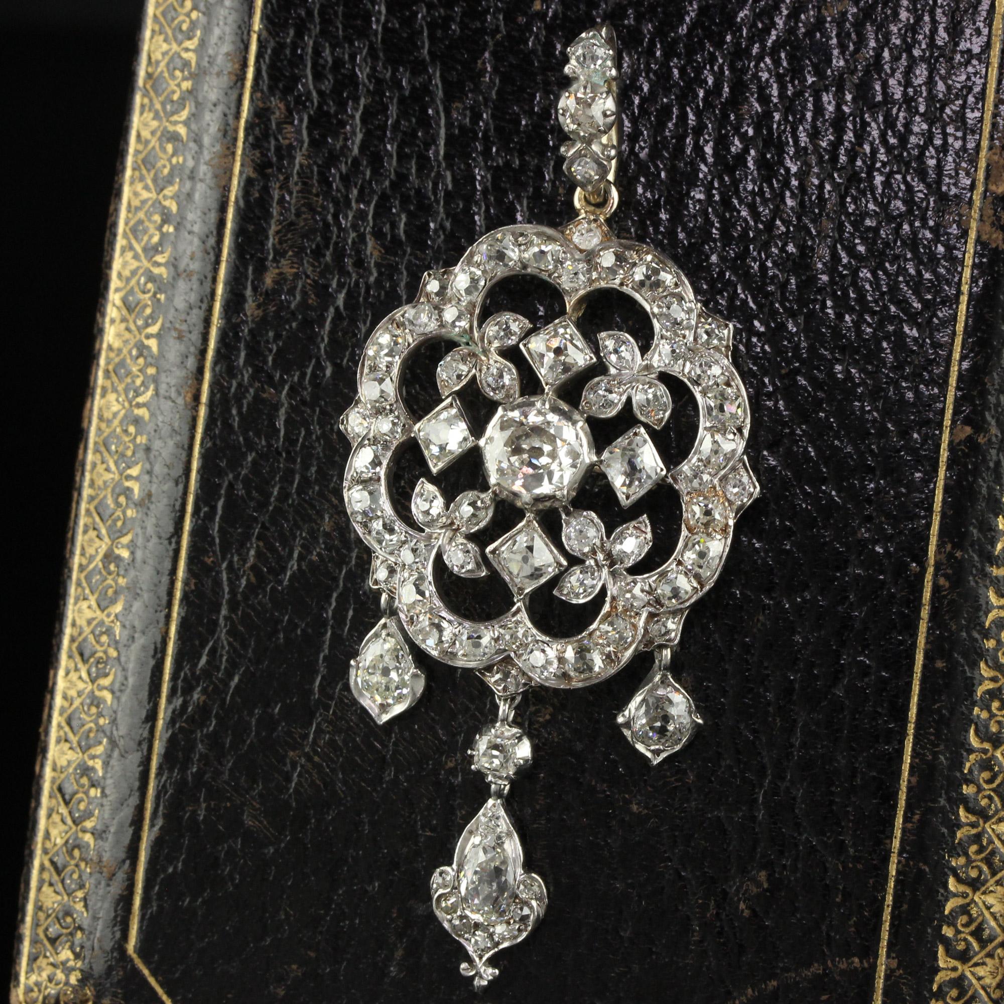 Beautiful Antique Victorian Silver and Gold Old Mine Cut Diamond Pear Shape Diamond Pendant and Pin. The pendant has old mine cut diamonds and very unique old pear shape diamonds hanging from the bottom. They are white and have beautiful sparkle on
