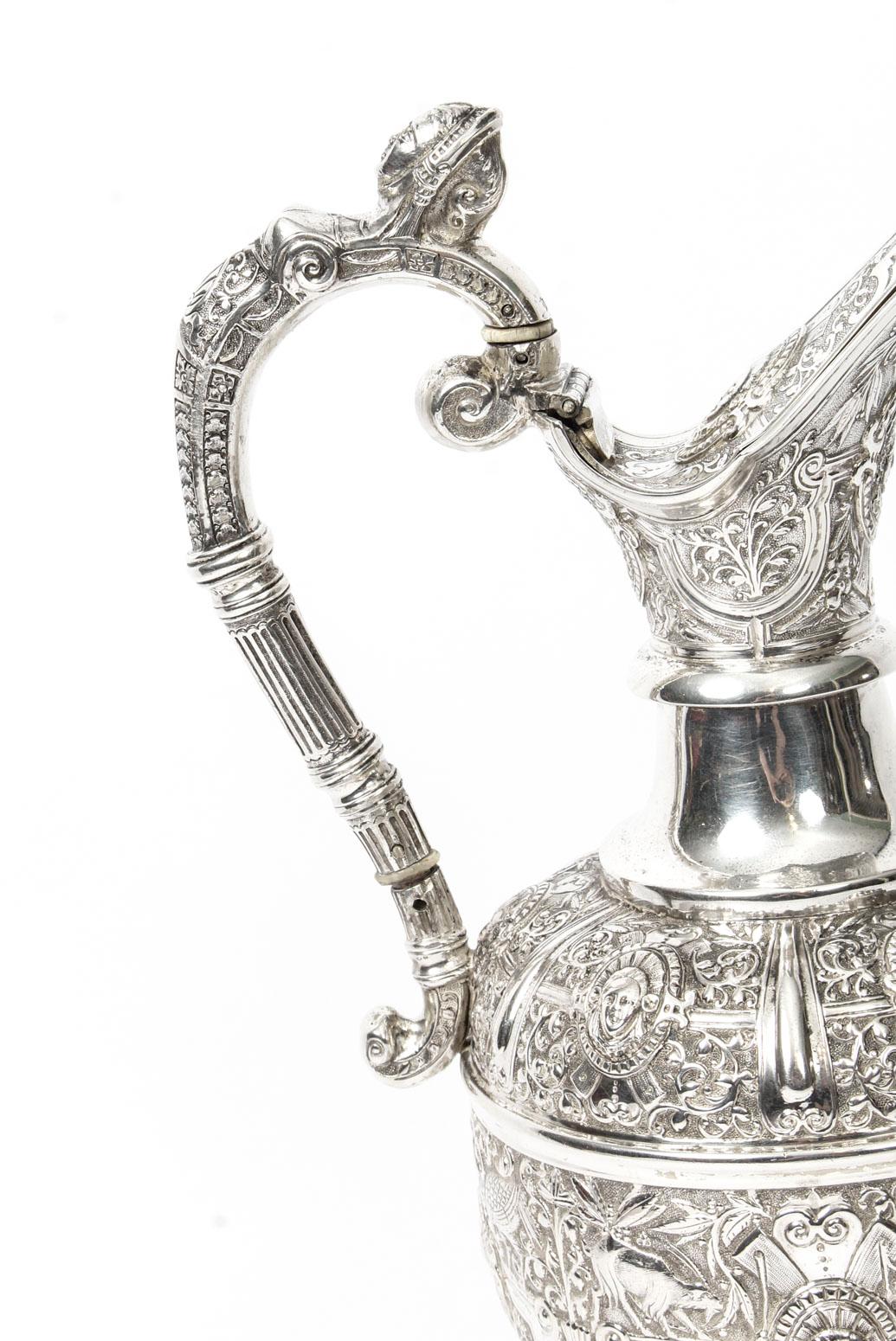 A wonderful antique English Victorian sterling silver claret jug with hallmarks for Glasgow 1878 and the maker's mark D.C.R, for the renowned Glasgow silversmith David Crichton Rait.

It has an impressive c scroll handle and is embellished with