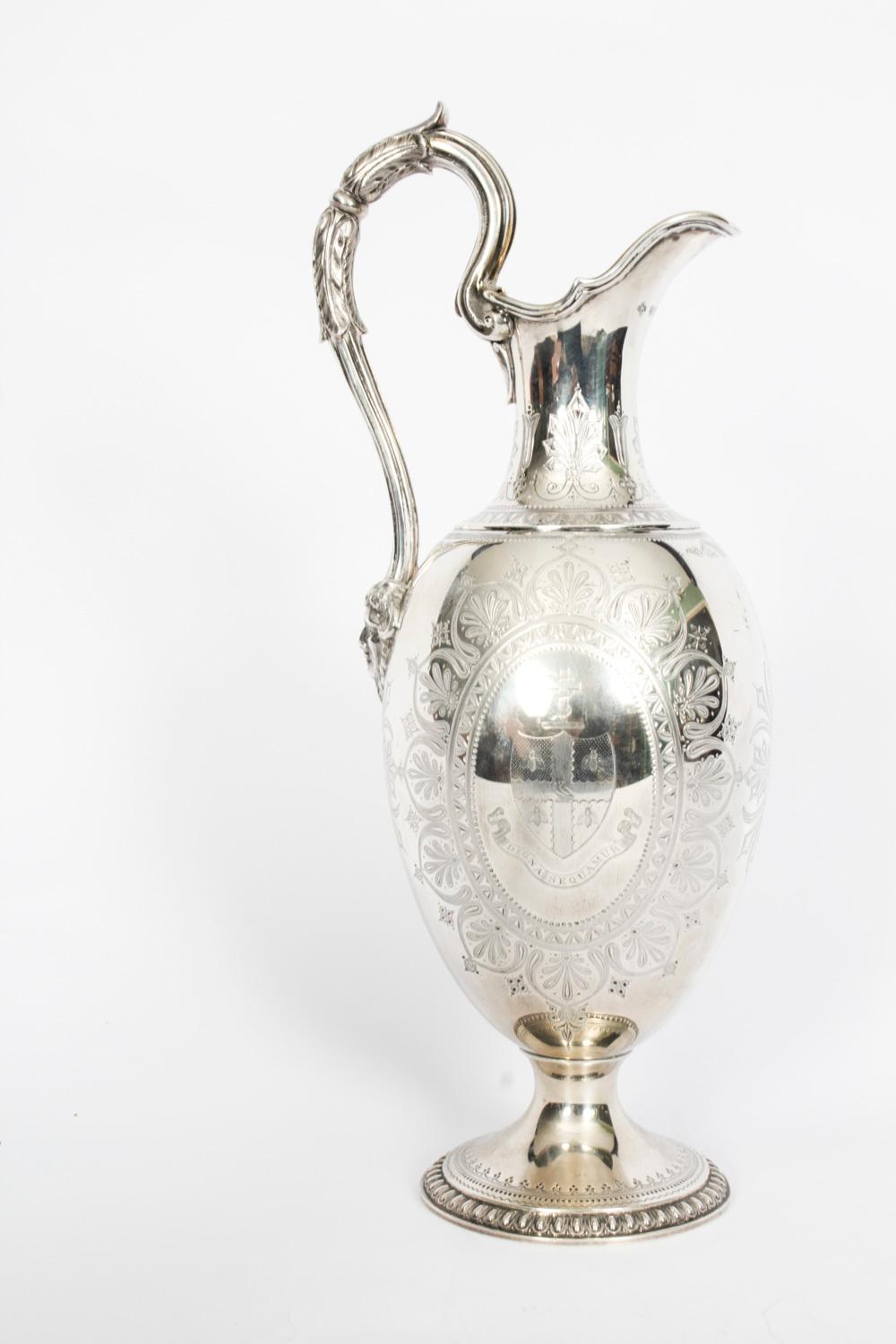 A wonderful antique English Victorian sterling silver claret jug with hallmarks for London 1876 and the maker's mark of the renowned silversmith Edward Barnard & Sons.
 
It has an impressive scroll handle and is embellished with the most wonderful
