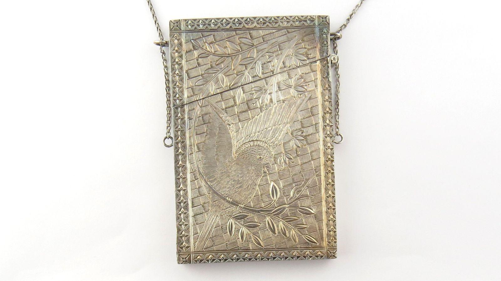 Antique Victorian silver coin metal calling card case. This stunning collectible calling card case is beautifully engraved with a lovely bird design with crosshatch background. Original chain with pinky holding ring. Size: 3.75 inches x 2.4 inches.