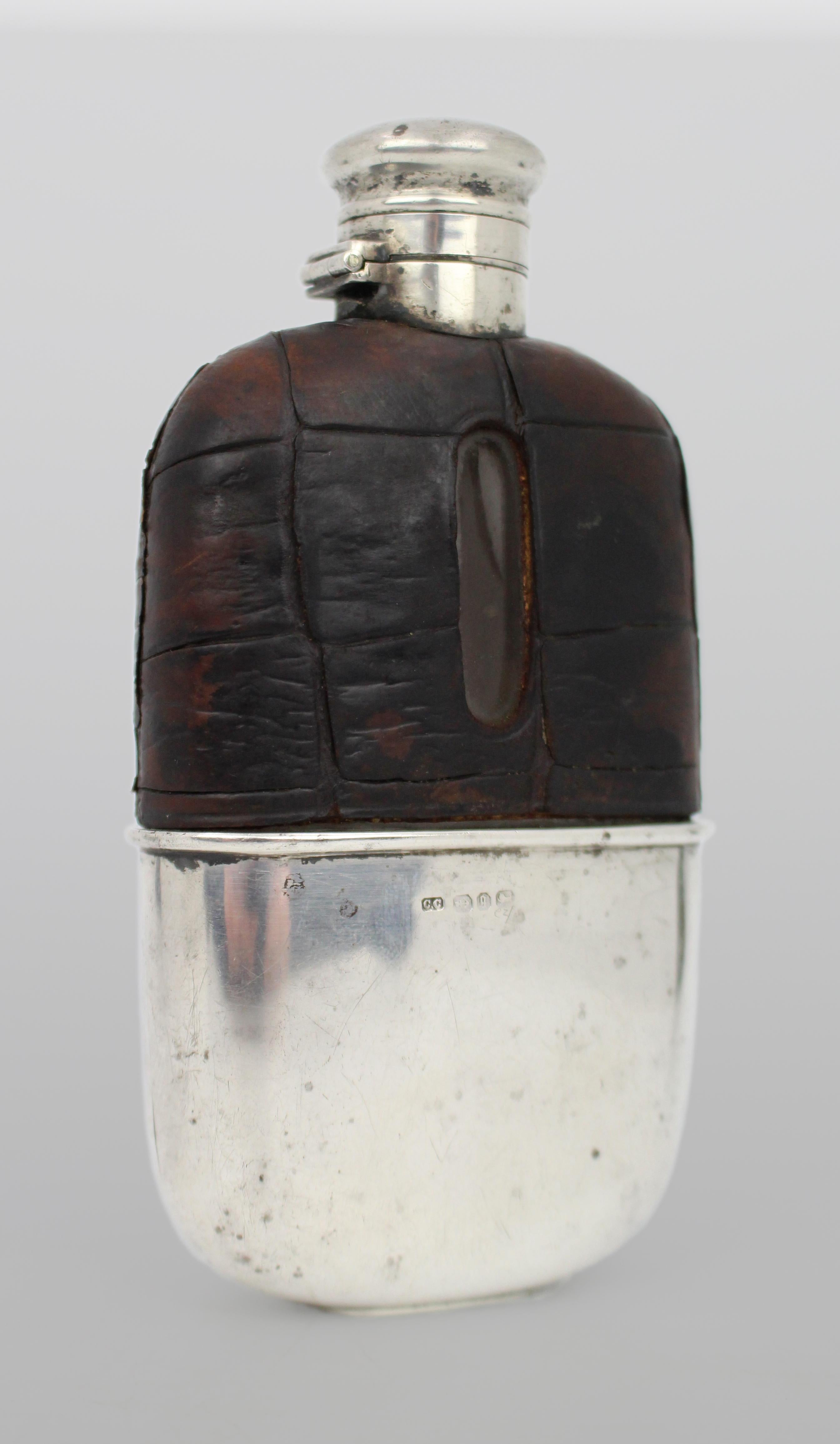 Antique Victorian Silver & Crocodile Leather Hip Flask – Birmingham 1890

A fine-quality late Victorian hip flask, crafted in 1890 by Colen Hewer Cheshire and assayed in Birmingham. The body is encased in crocodile hide leather with a glass inner,