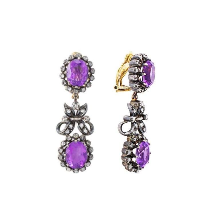 Part of a Victorian set of earrings and a necklace, dated to the 1900s, this is a silver necklace set with 4 purple amethysts and 108 rose cut diamonds. The oval amethysts weigh a total of approximately 13cts and the diamonds weigh a total of