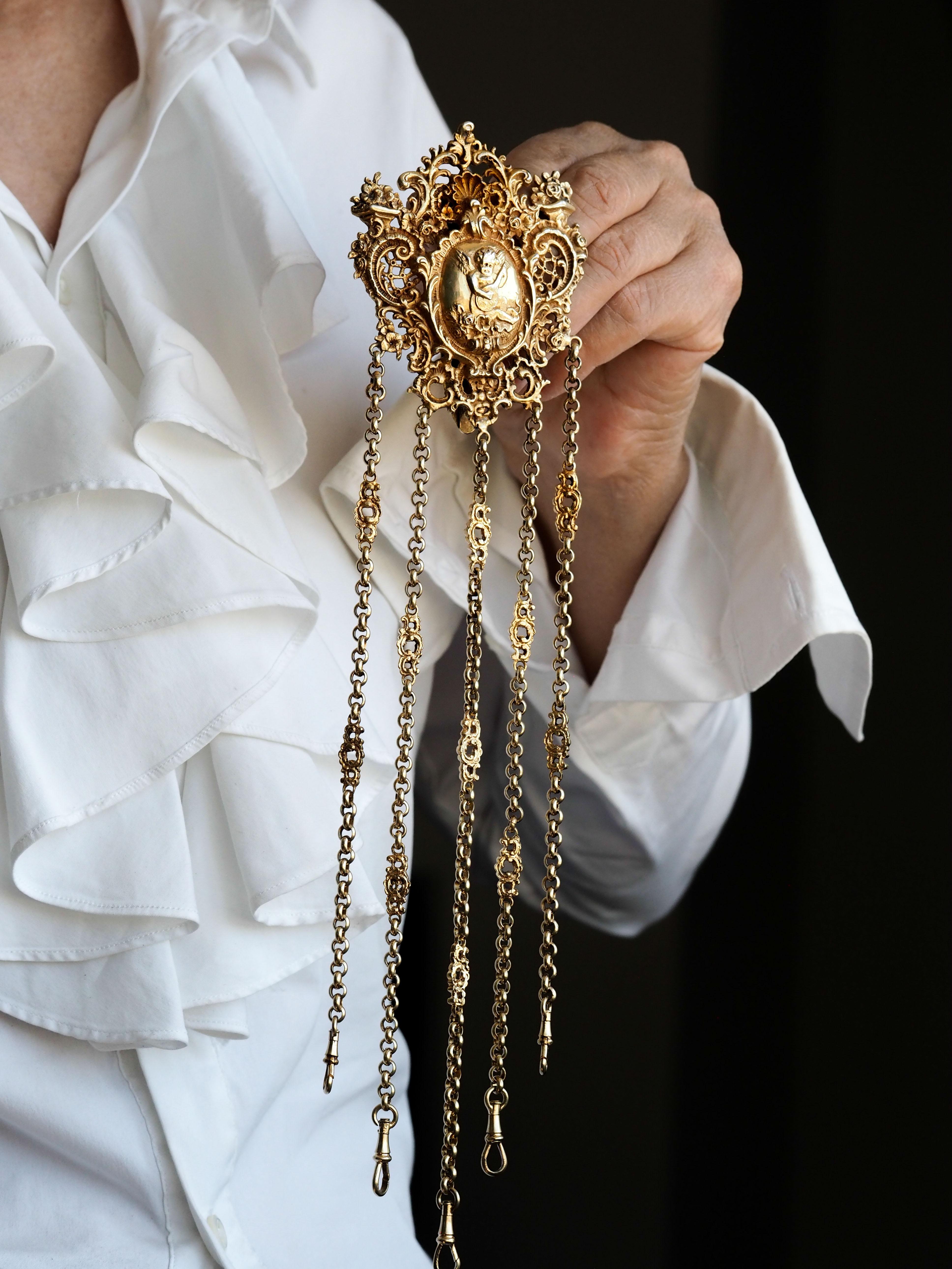 We are delighted to offer this stunning antique solid silver gilt chatelaine made c.1860 likely in German or continental Europe. 

No spot left unembellished, this chatelaine presents itself with exceptional splendour and extravagance, being fully