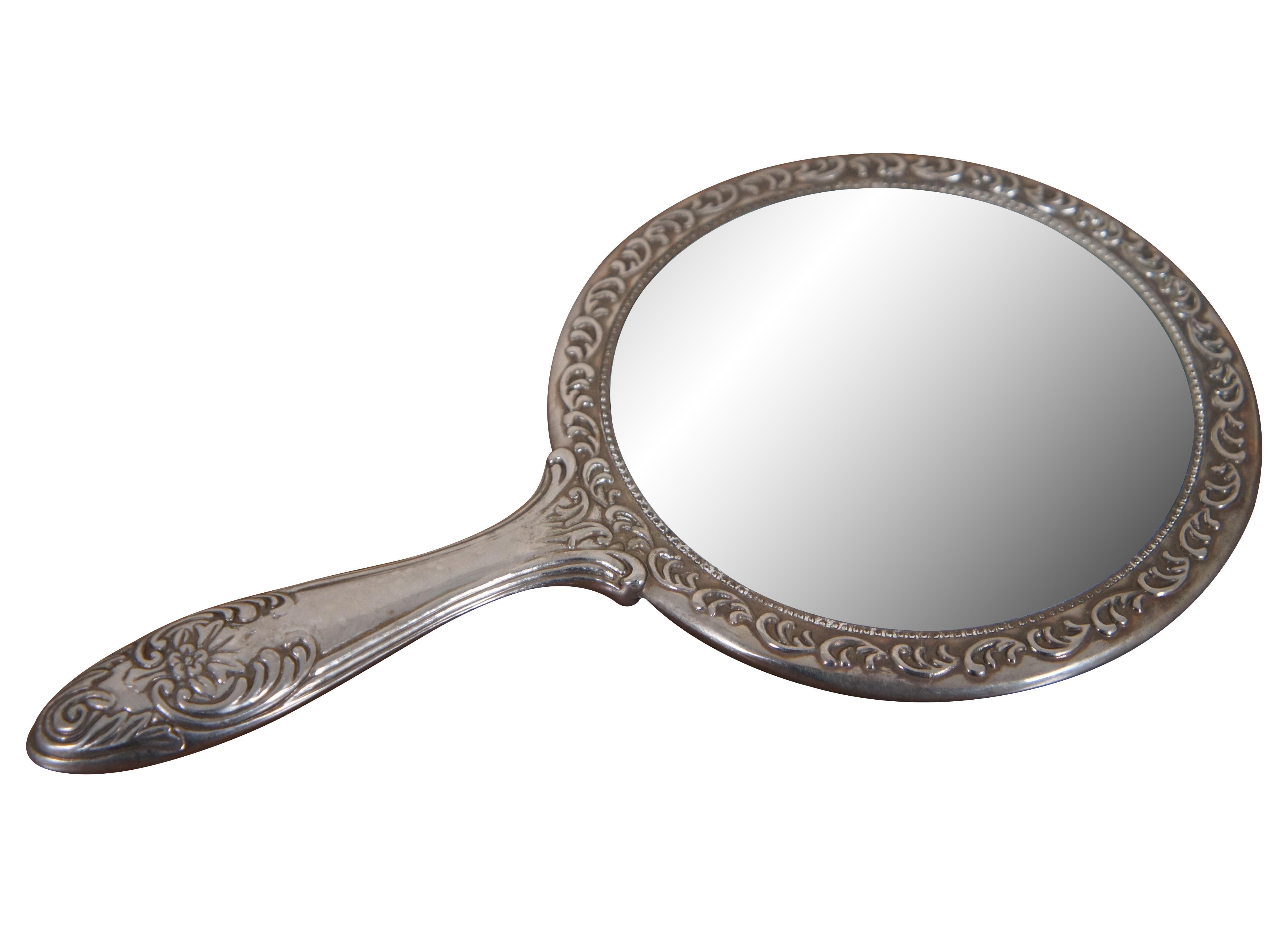 Antique Victorian Silver Hand Mirror. Features a beautiful repousse design of foliate / flowers. Unmarked. Measure: 9