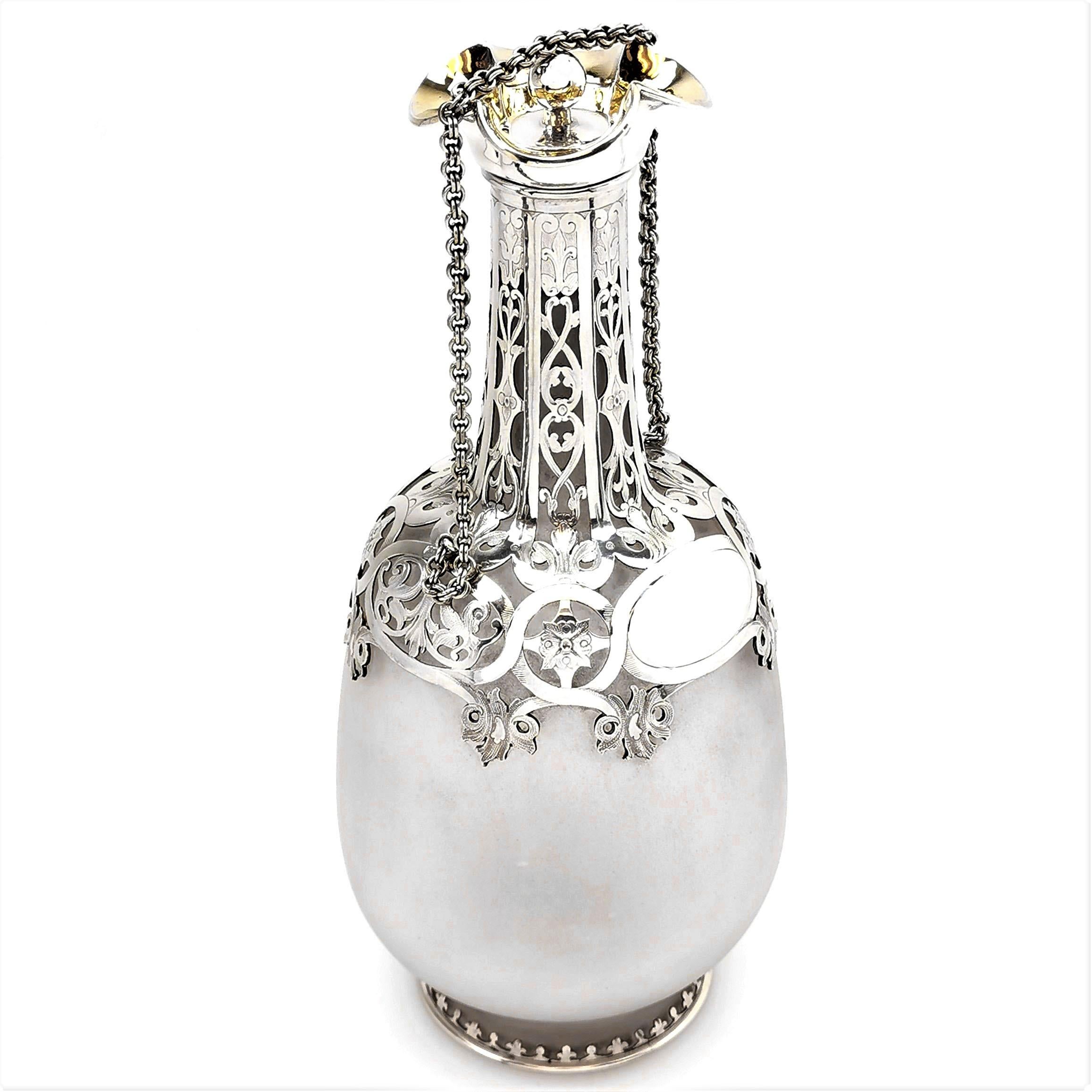 A beautiful antique Victorian sterling Silver and Glass Decanter in the shape of a Pilgrims Flask or Bottle. The Decanter has a frosted glass body and a silver neck and foot. The Silver Decanter has an elegant pierced and engraved design that