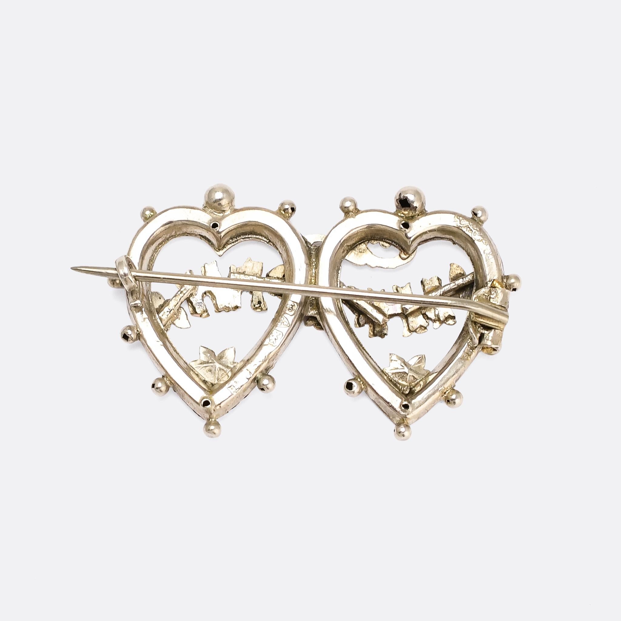 A fine quality antique double heart MIZPAH brooch dating from 1901. It's crafted in sterling silver, with applied rose and yellow gold letters, flowers, and ivy leaves.

Mizpah jewellery symbolises a bond between two estranged parties, with God as