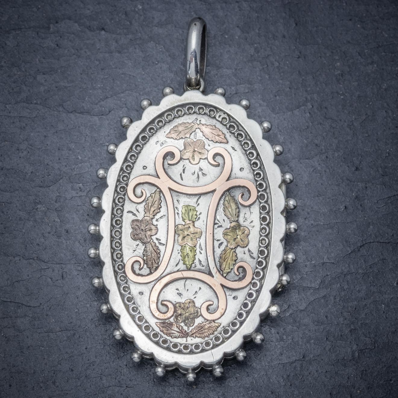 A stunning antique Victorian floral locket C. 1880, engraved with beautiful Forget me nots highlighted in a high carat Yellow/ Rose Gold. 

The locket is fashioned in Silver and haloed with Silver balls and a lovely patterned border.

Complete with