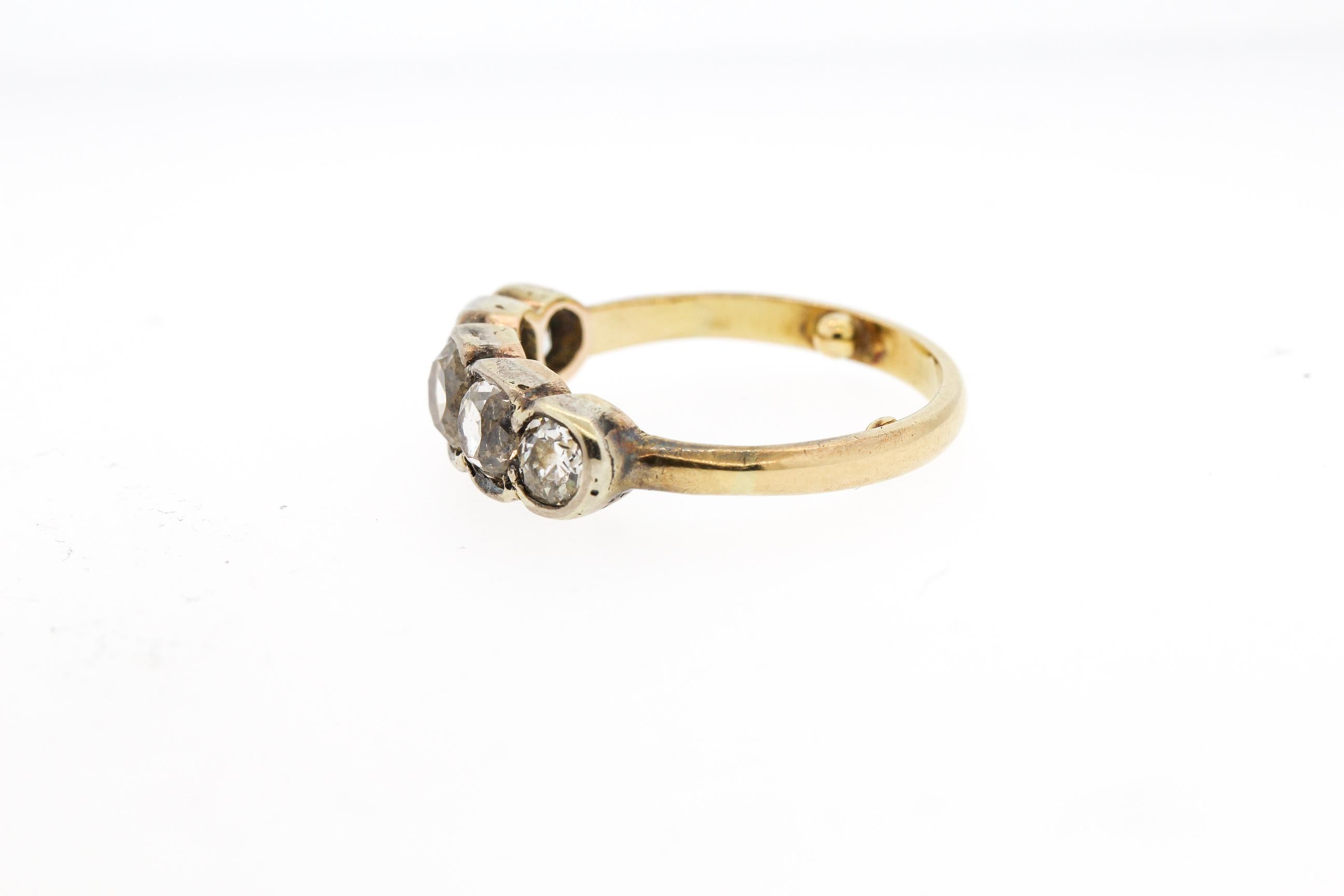 Victorian silver and gold five stone diamond ring set with Old Mine Cut diamonds. The ring is made in 18k and dates to about 1850. The ring is gold, though the top part is topped in silver. The five stones weigh approximately 1.65 carats total. The