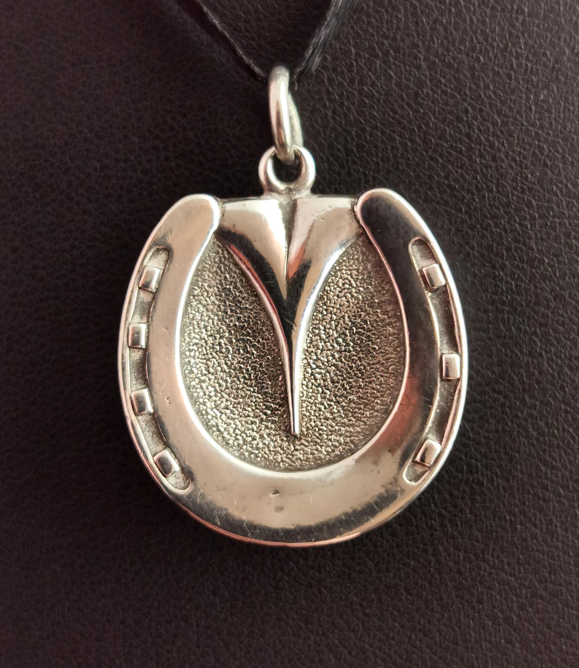 A beautiful and interesting antique silver horse hoof locket.

It is a dainty size but is quite chunky with a three dimensional shape to it and lots of realistic detailing.

The reverse of the locket opens up to reveal a glazed compartment to the