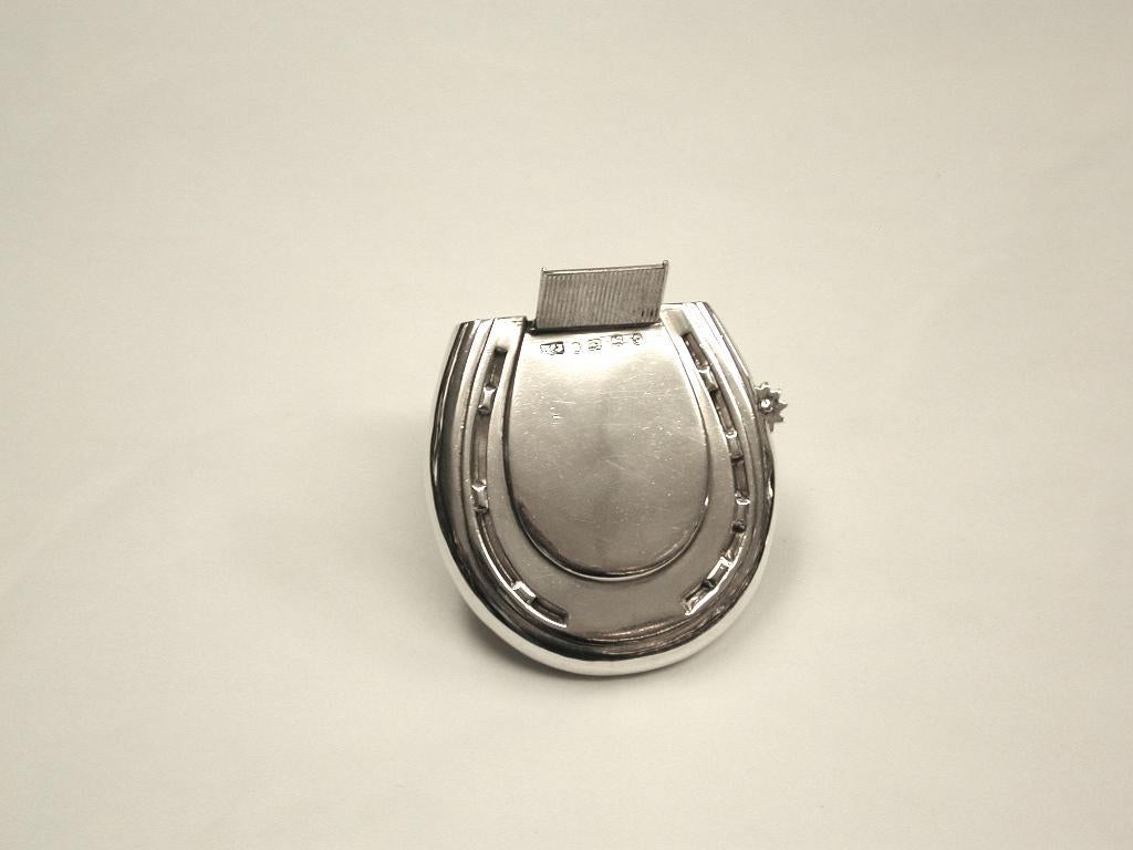 Antique Victorian silver horseshoe shaped vesta case, dated 1881, made in Birmingham.
Unusual silver vesta case with external tube for tinder
cord for lighting several cigars at a gentleman’s gathering.
The inner compartment holds the matches,