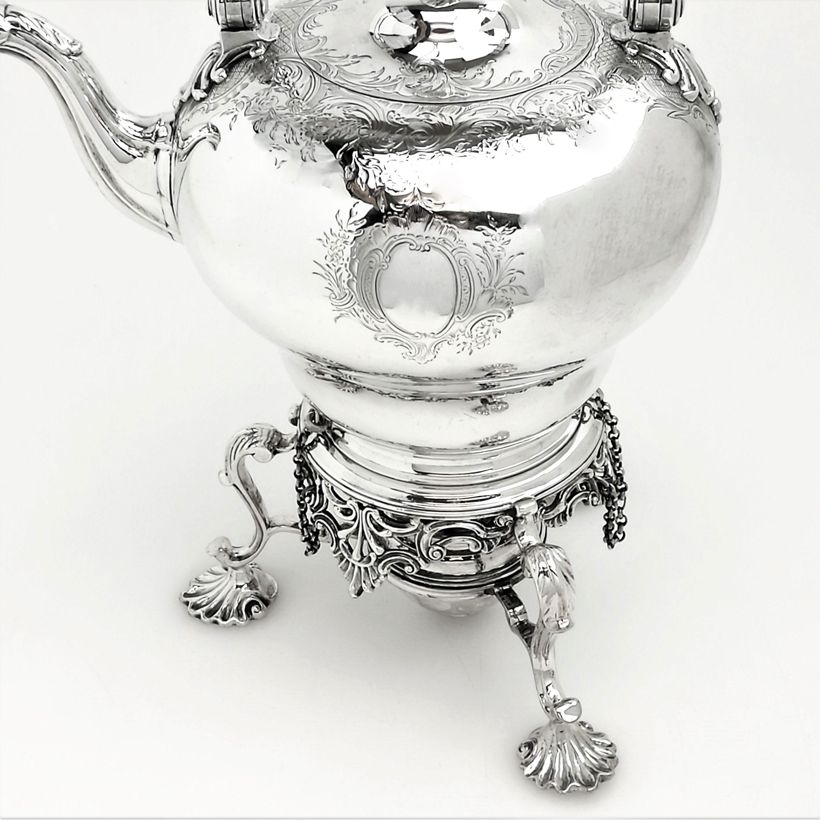 silver teapot on stand with burner