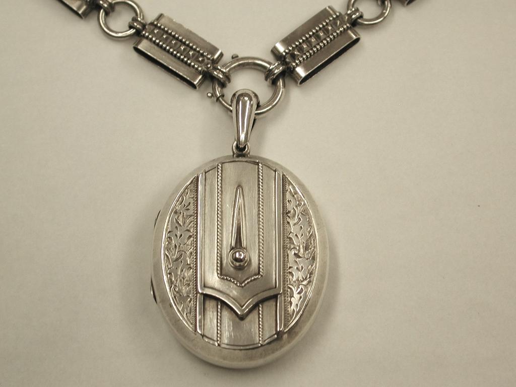 Antique Victorian silver locket and collar, dated circa 1880
The collar has a heavy gauge of silver with unusual alternate links,
hollow diamond cut beaded oblongs interspersed with round hollow links.
The Locket is marked sterling on the top