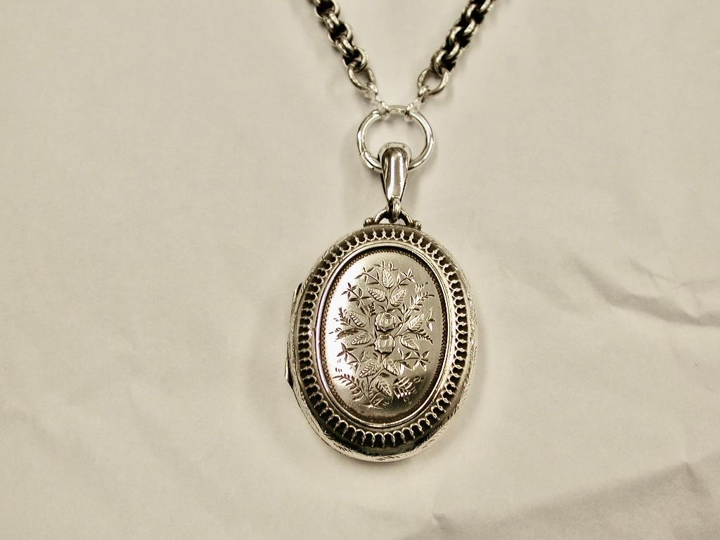 Antique Victorian Silver Locket & Chain,Dated 1881.
Assayed in Birmingham in 1881 made by Ward & Francis
The chain is a ribbed belcher style from the same period.
The locket is beautifully hand engraved with applied border and flowers.