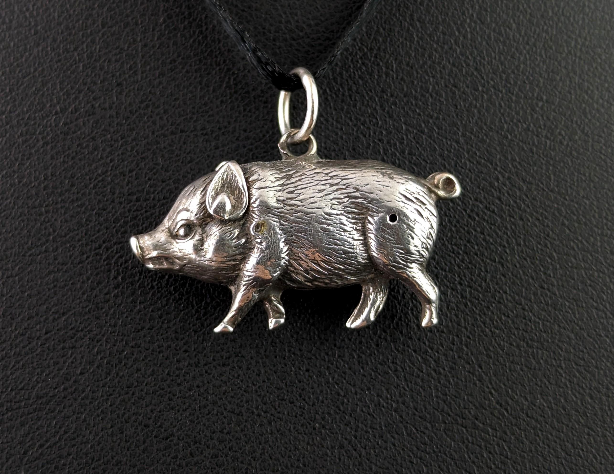 There are two sides to every Piggy! At least on this antique silver lucky pig pendant there are.

I have to admit I really love the character of this piece!

It is a chunky little sterling silver piggy with an integral silver jump ring bale making