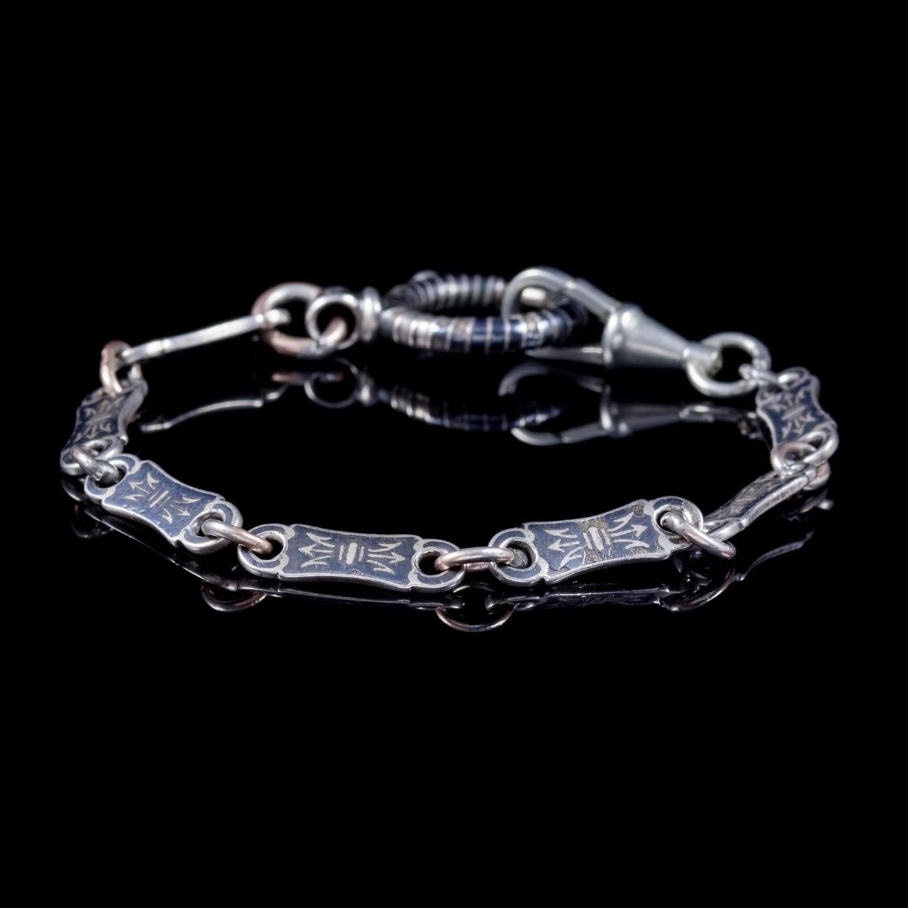 A quality antique Victorian bracelet C. 1900, made up of lovely Silver links with black Niello artistry displayed throughout. 

Niello is a black alloy that fuses into an etched or engraved metal base to create a fabulous decorative effect that