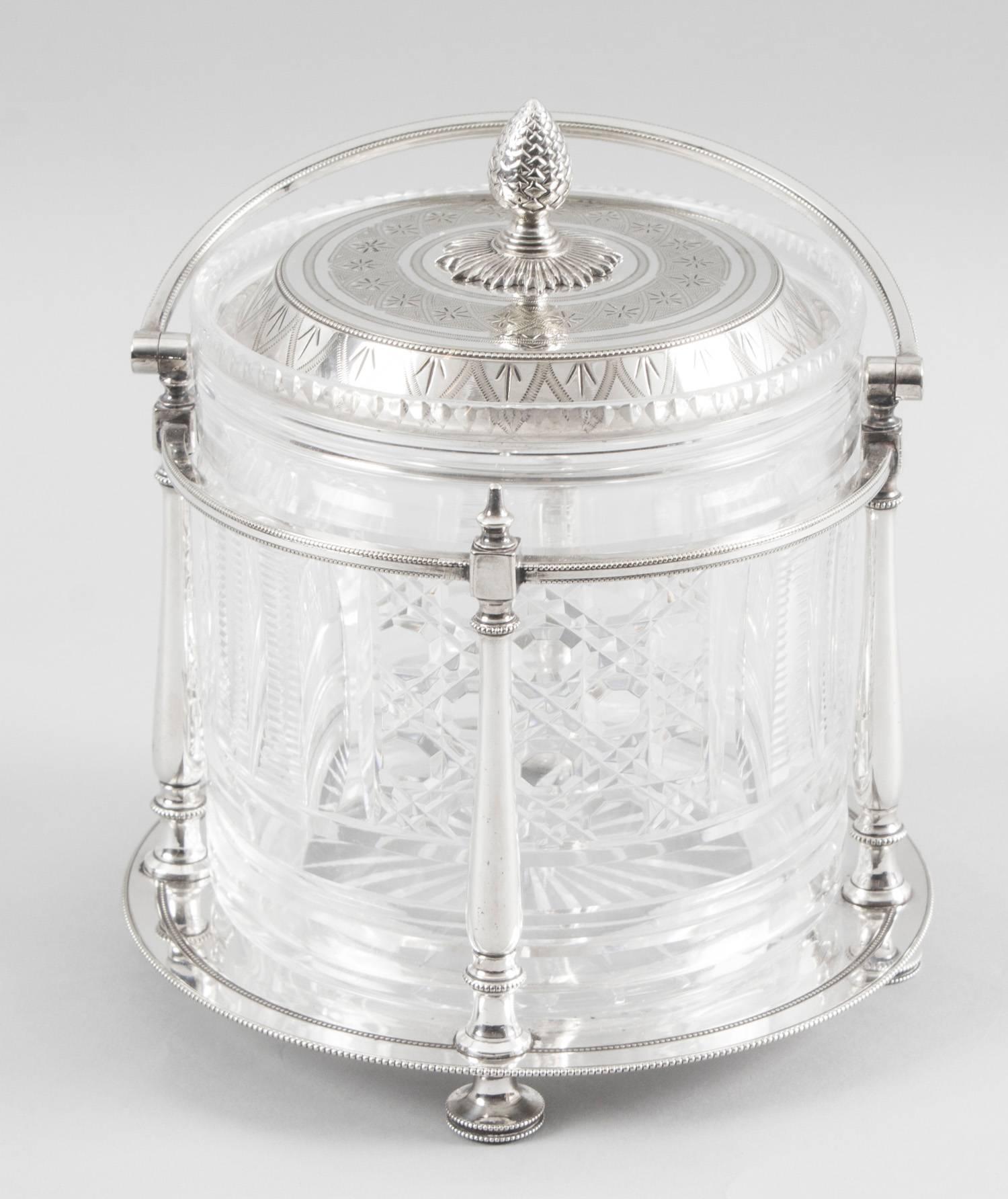 This is a lovely antique Victorian silver plate and cut glass biscuit barrel, circa 1870 in date.

This delightful piece features a cut glass biscuit barrl in a silver plated swing-handled frame with turned columns and beaded decoration, a