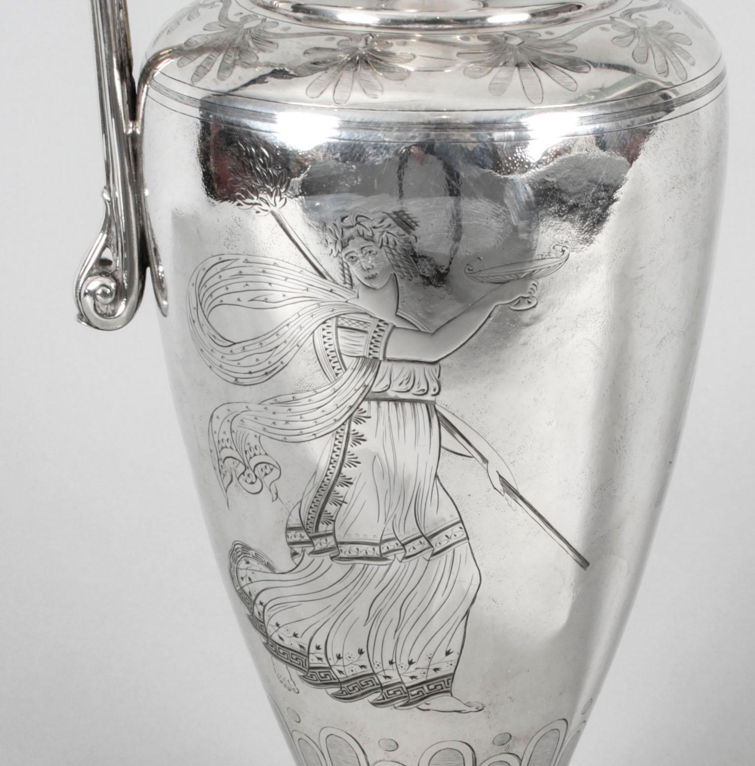 This is a fine Victorian silver plated claret jug, bearing the makers' mark of the renowned silversmiths, Elkington of Birmingham and dated 1864.
 
 This claret jug has a charming classical urn shape, stands on an egg and dart decorated circular