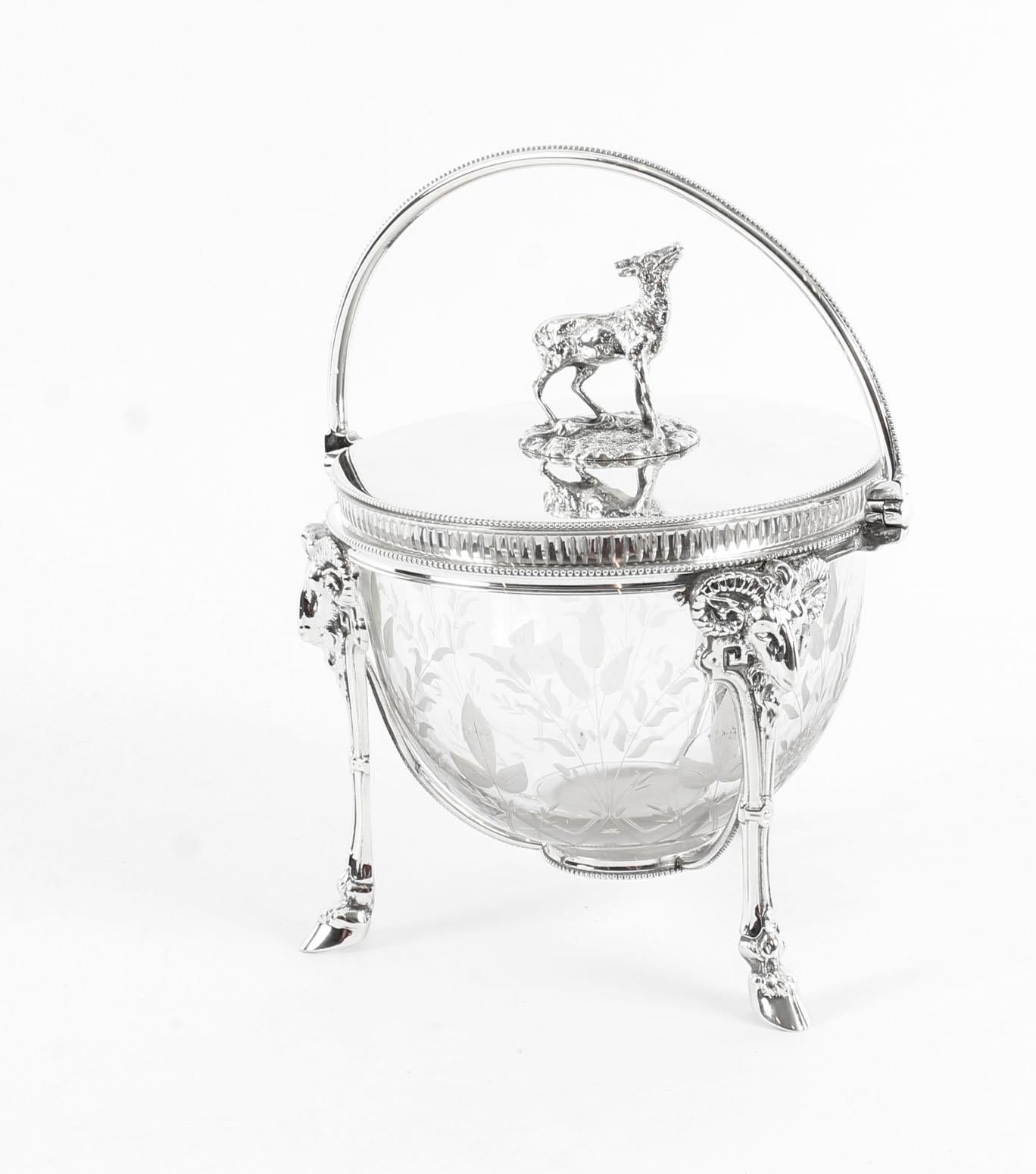This is an exquisite antique Victorian silver plated and engraved crystal biscuit box, circa 1860 in date.

The round lift up lid features a free standing deer finial and is fitted with a swing handle. The wonderful engraved crystal cylinder is