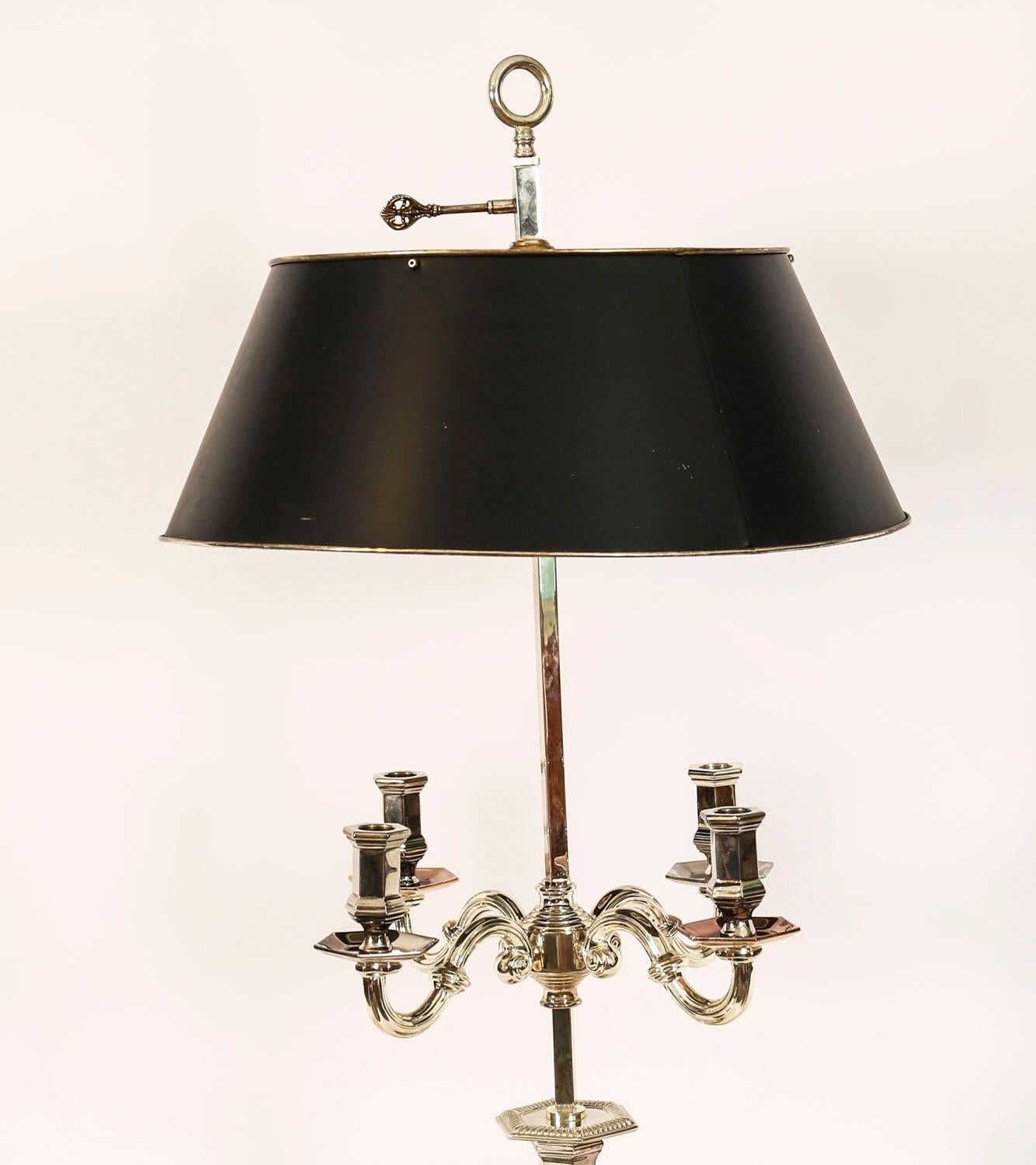 This is a splendid antique Victorian revival silver plated candleabra table lamp with rise and fall tole Bouillotte shade, Circa 1920 in date.

This opulenttable lamp features four decorative candleabra arms and a central lamp stem, decorated with