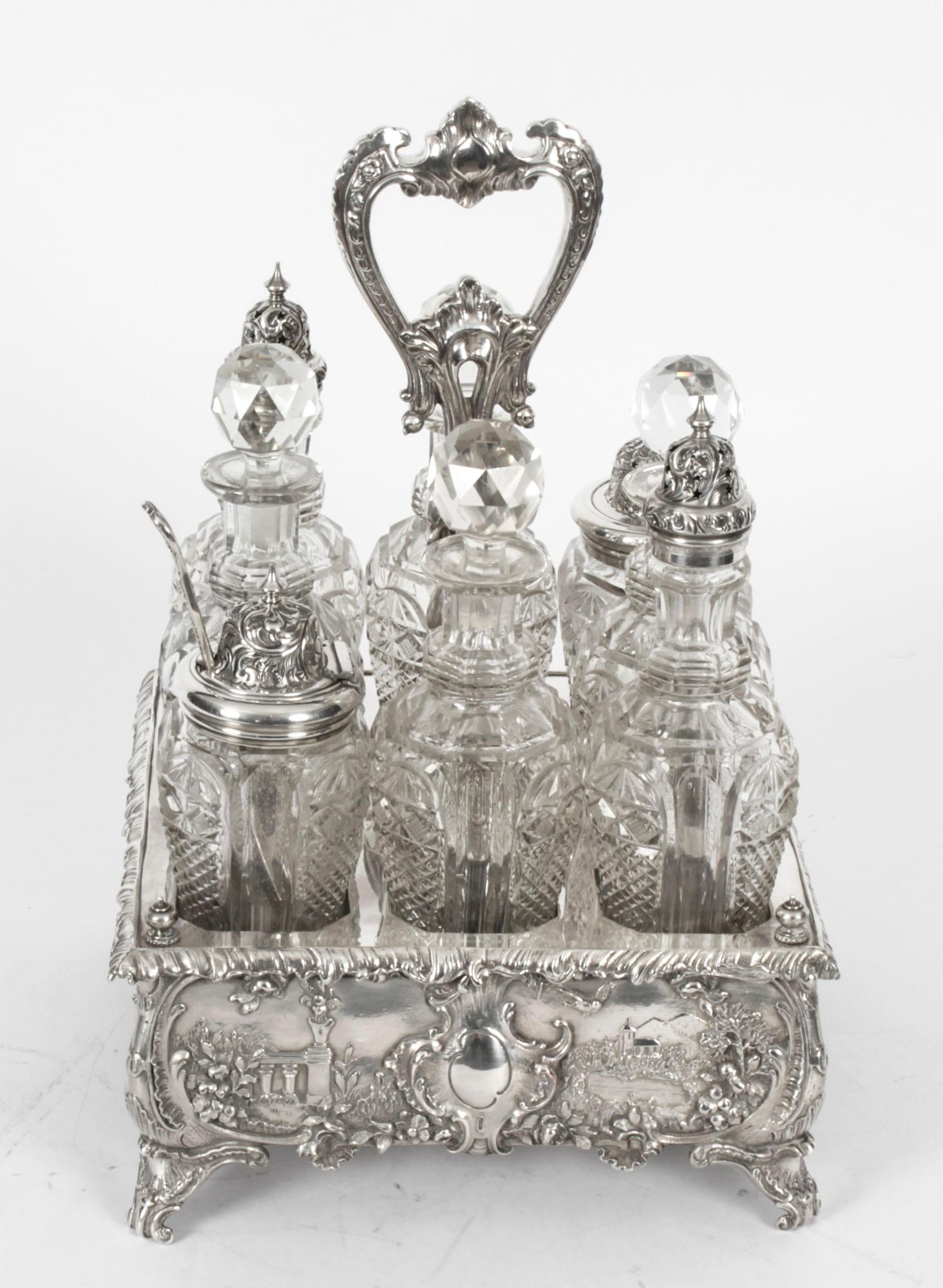 This is a gorgeous antique silver plated cruet set bearing the makers mark of the renowned silversmith family, Walkers and Hall, and circa 1845 in date.
 
The set comprises a beautifully decorative silver plated cruet Stand holding eight exquisite