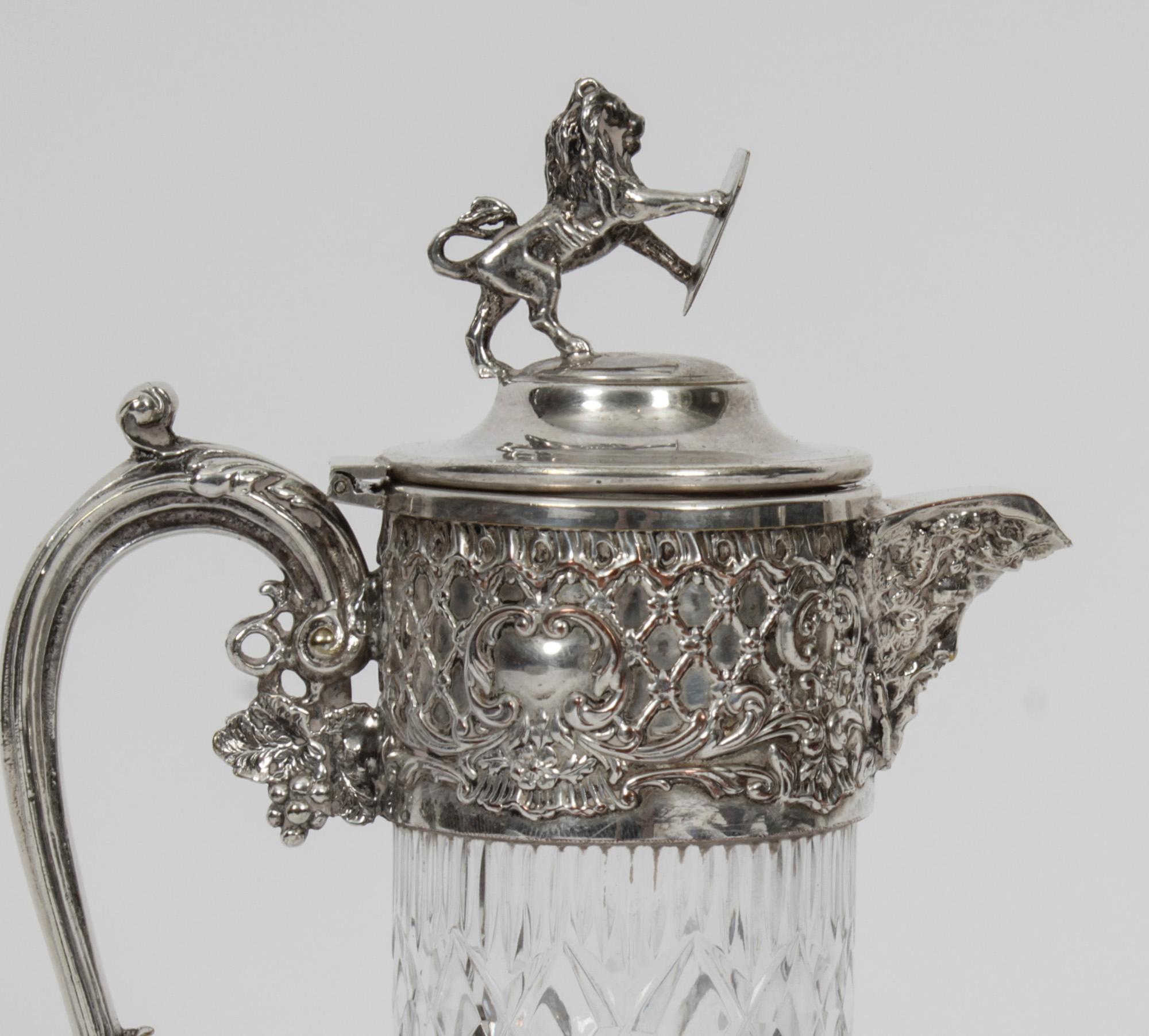 This is a wonderful antique victorian silver plated claret jug, circa 1870 in date

The claret jug has beautiful vinious decoration, a face mask spout, a hinged lid surmounted with a lion holding a shield and is silver plated on copper. 

The