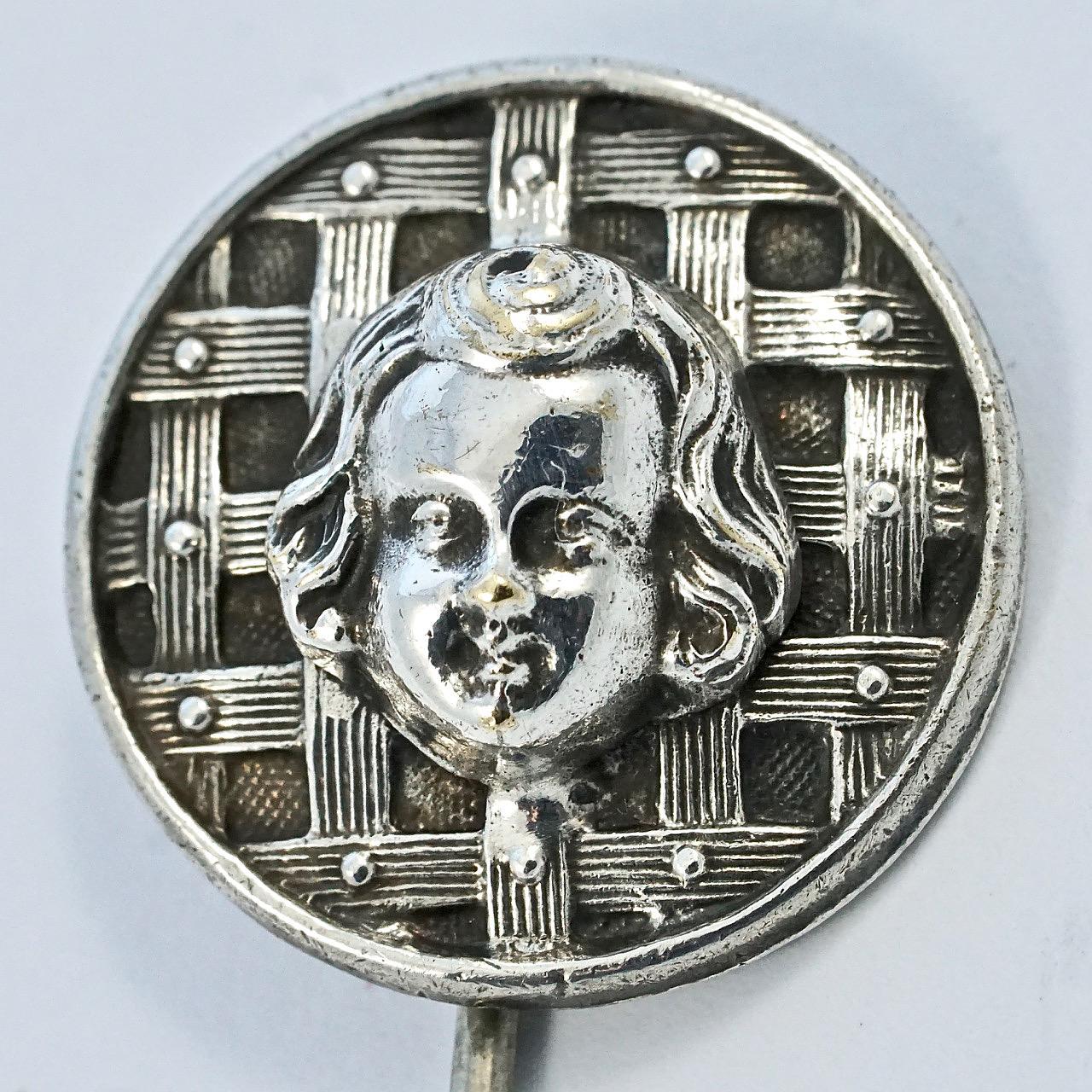 Wonderful antique Victorian silver plated stick pin, featuring a lovely cherubic face on a detailed woven and dot design. The stick pin does not test for silver. Measuring diameter 1.8cm / .7 inch. The ridges on the stick help it to hold on to