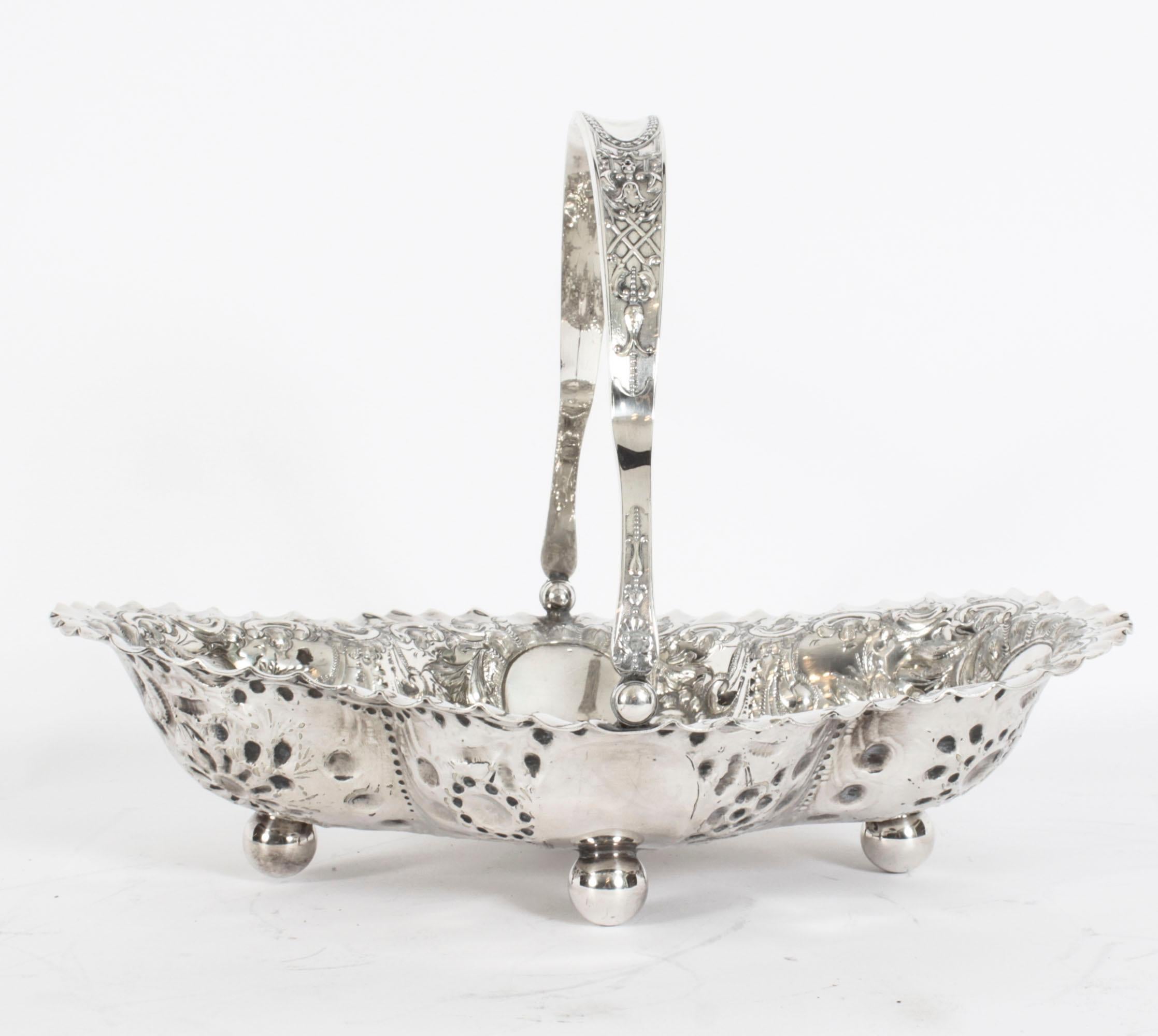 This is an exceptionally fine antique English Victorian silver plated fruit basket with hallmarks for the celebrated silversmith, James Dixon, circa 1880 in date.
 
This magnificent basket has a shaped swing handle on a flared shaped oval basket