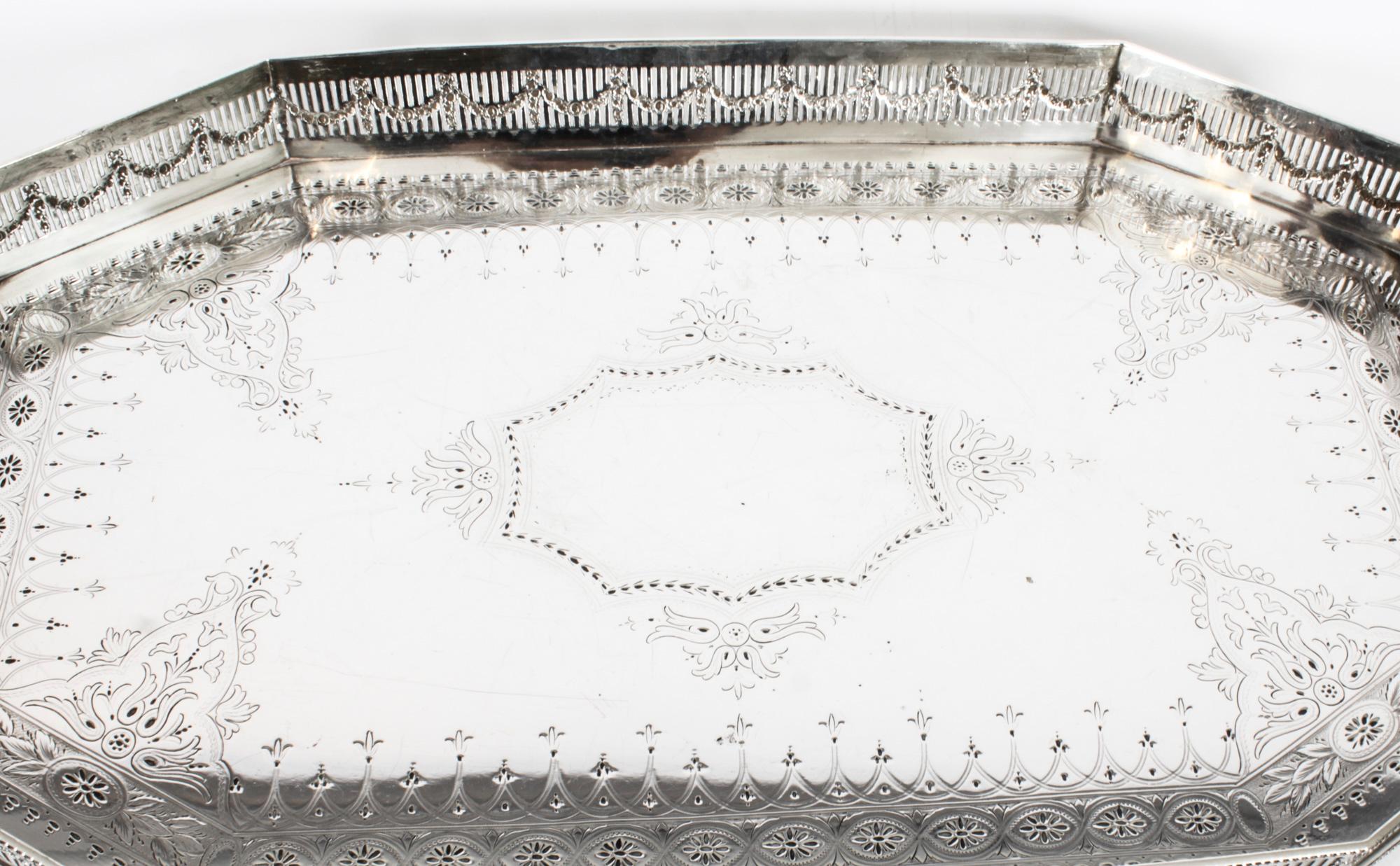 This is a lovely antique Victorian silver plated gallery tray with beautiful engraved decoration bearing the makers mark of the renowned silversmith Grant & Son, and dating from Circa 1890.
 
This shaped rectangular tray with cut off corners