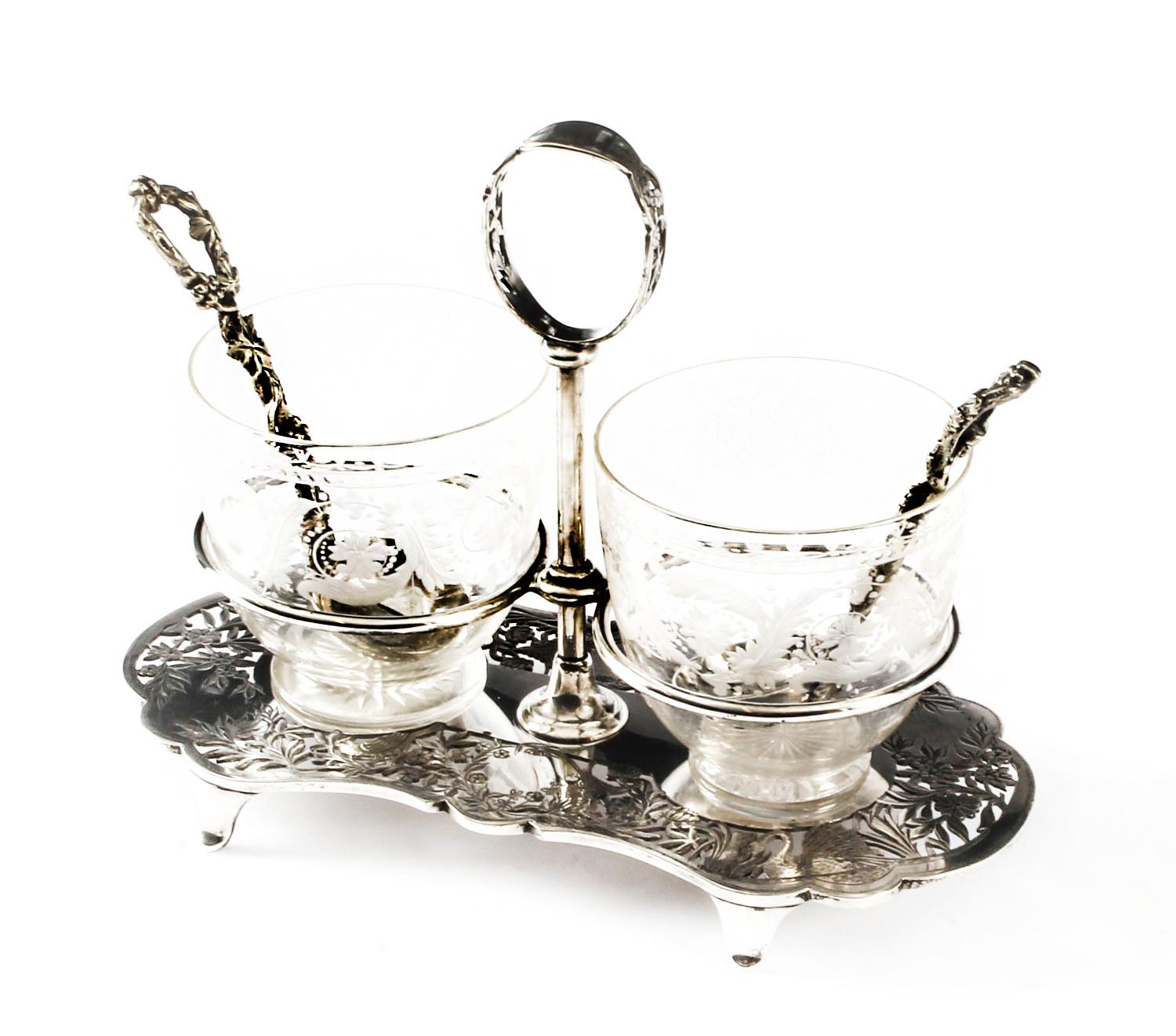 This is a delightful antique English Victorian neoclassical silver plated and etched glass strawberry & cream set circa 1870 in date.
 
This splendid set features beautiful etched glass bowls on a fitted Stand decorated with pierced foliate and
