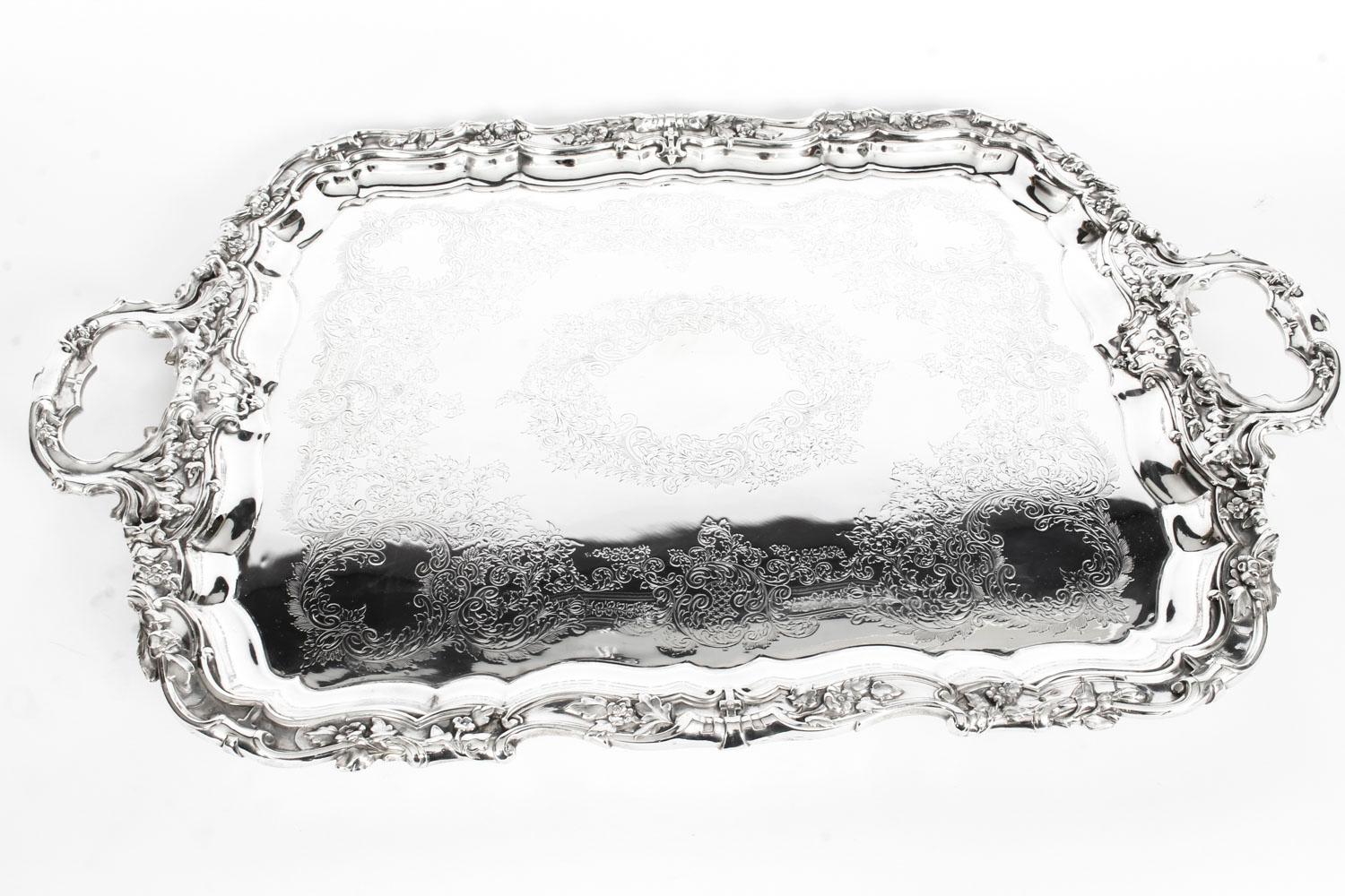 This is an exceptional large neoclassical antique English Victorian silver plated service tray by the renowned silversmith Walker & Hall Sheffield, circa 1870 in date.

The rectangular tray features elegantly engraved foliage decoration to the