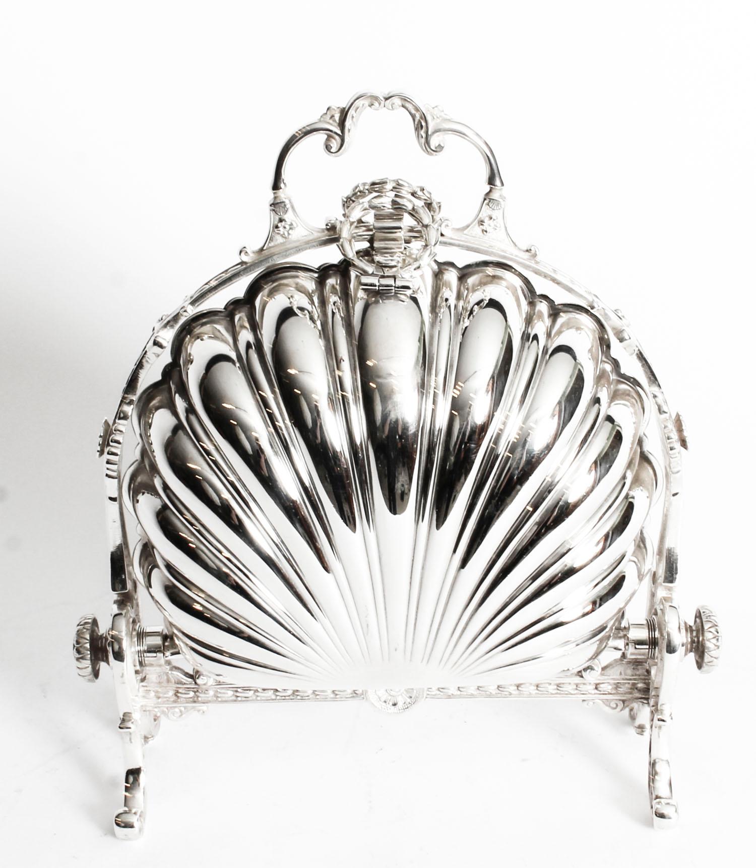 This is a highly decorative antique Victorian silver plated folding biscuit box, the base bearing Patent N&H 350 85, circa 1880 in date.
 
It has a scalloped shell-shaped body sitting in a cast frame with remarkably chased branch supports and the