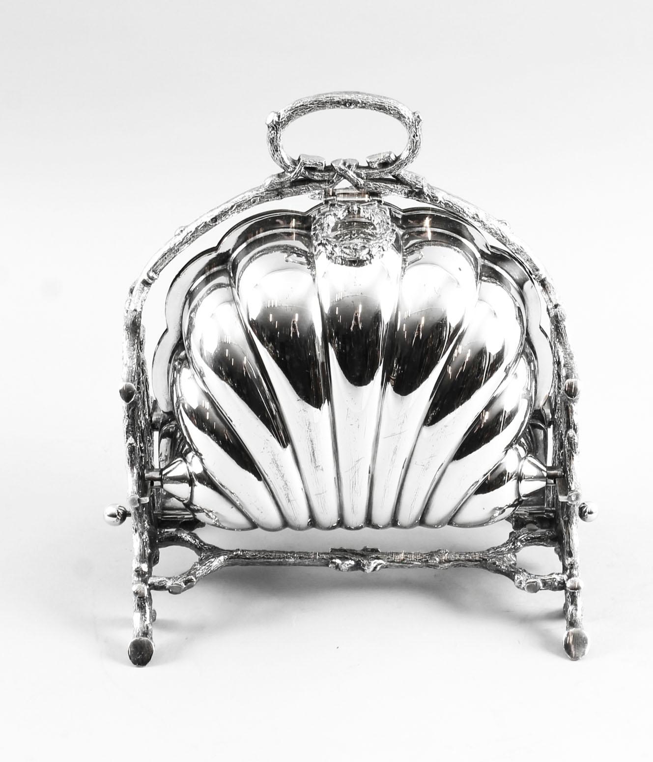 This is a highly decorative antique Victorian silver plated folding biscuit box, the base bearing the makers' mark of the renowned silversmiths Walker and Hall of Sheffield, England, circa 1880 in date and bearing the registration number 36762.