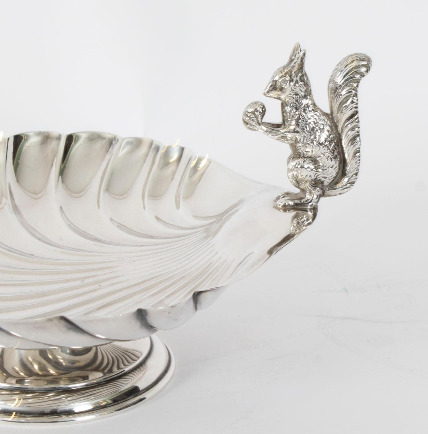 This is a stunning antique English Victorian silver plated nut dish or sweet dish, by the silversmith William Hutton & Sons of Sheffield with the Crossarrows mark and dated Circa 1880.

It features a fabulous embossed body with a squirrel eating a