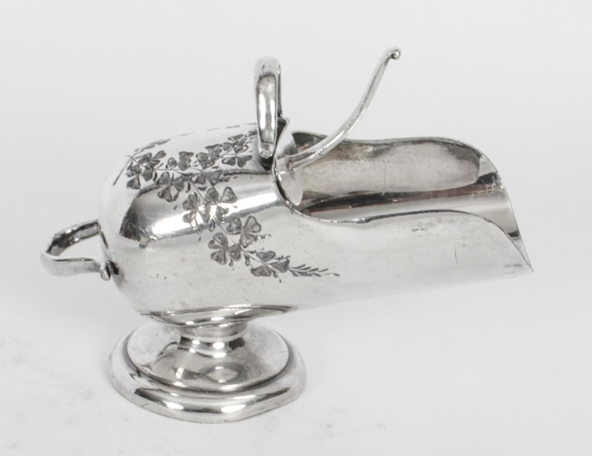A charming and unusual Victorian silver plated sugar bowl in the form of a coal scuttle with a shovel as the spoon, marked C & C over C into a trefoil, circa 1860 in date 

The cylinder shaped bowl features a front and back handle and sits on a