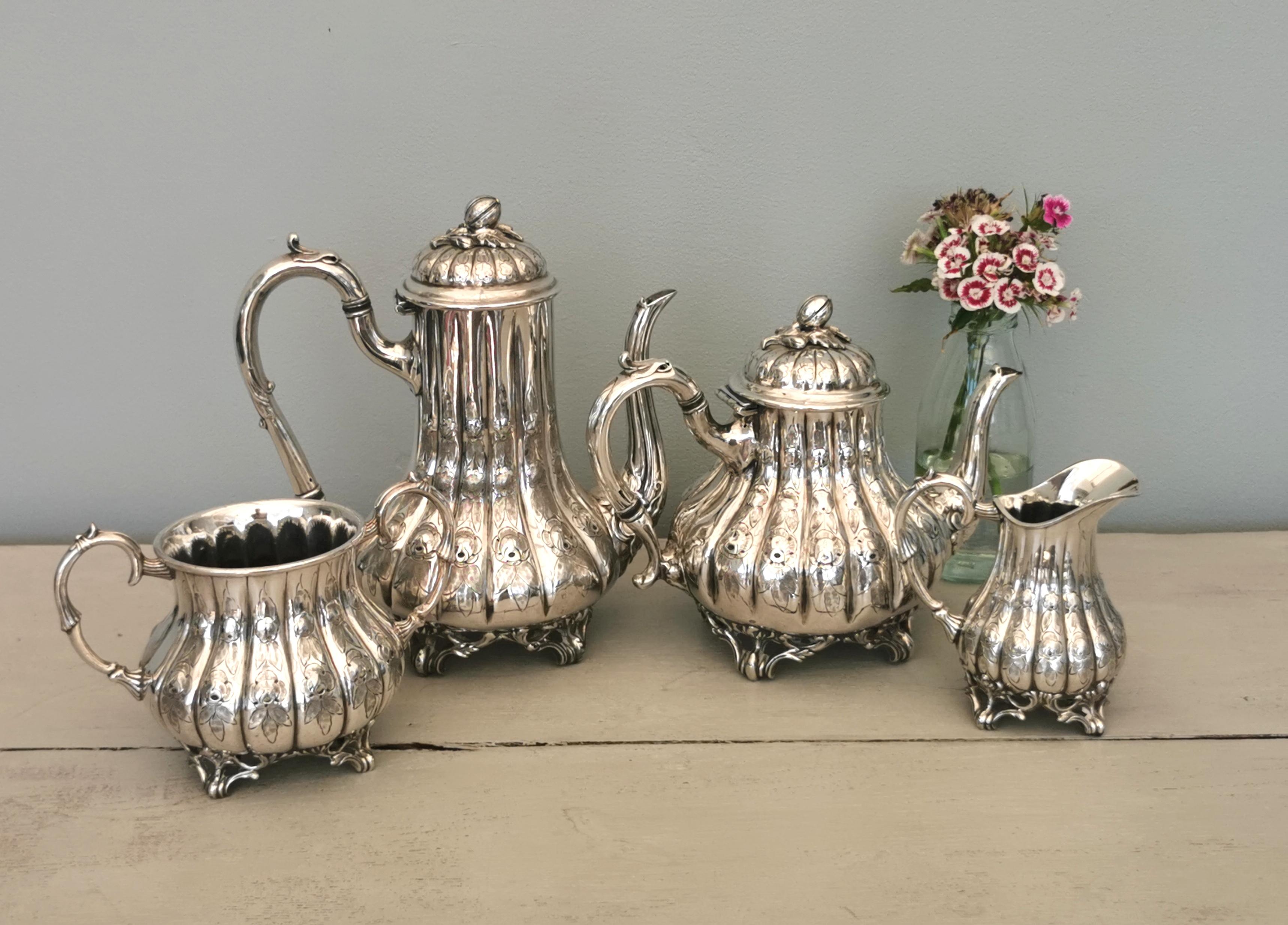 This is one very fine and grand Victorian tea set.

It is a four piece set, very elaborate, the pieces have wide bulbous bases and are each engraved with roses and all stand raised on scroll feet.

The pieces are crafted in very high quality silver