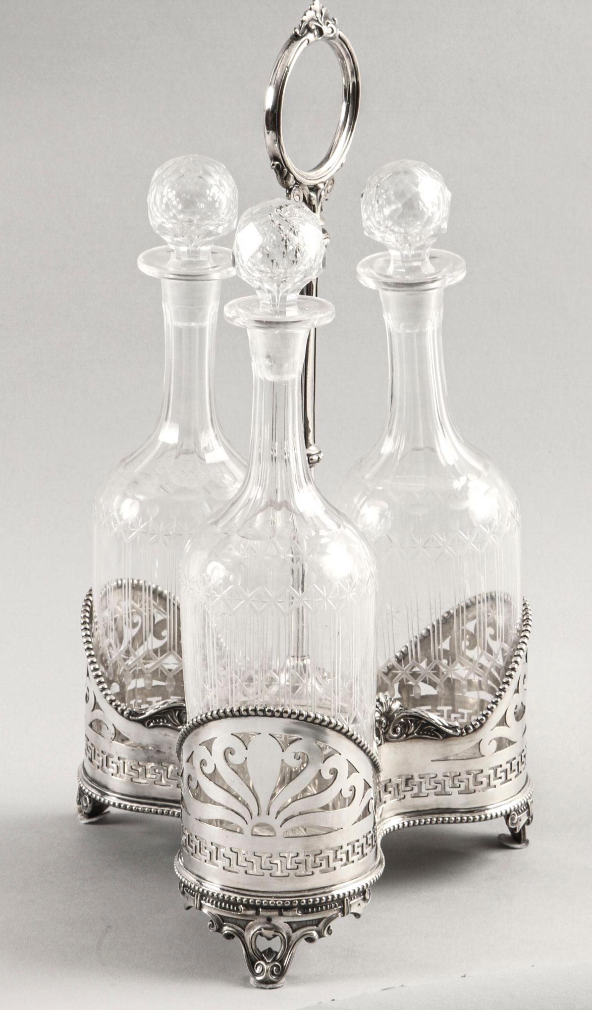 This is a lovely attractive antique Victorian silver plated tantalus with three cut glass decanters and stoppers, circa 1870 in date.
 
The cut glass decanters feature oval and beaded facet cut linear decoration with facet cut stoppers. The silver