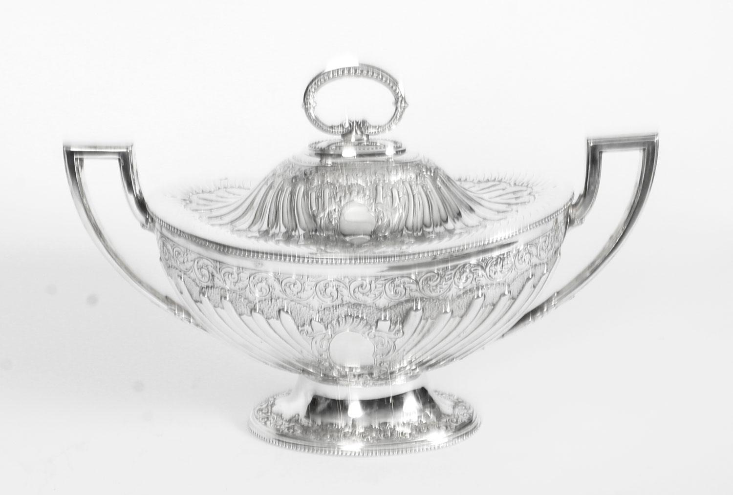 This is an exquisite antique English Victorian silver plated soup tureen, circa 1860 in date.
 
This splendid tureen is oval in shape with delightfully embossed foliate and fluted decoration. The handle is removable and has wonderful beaded