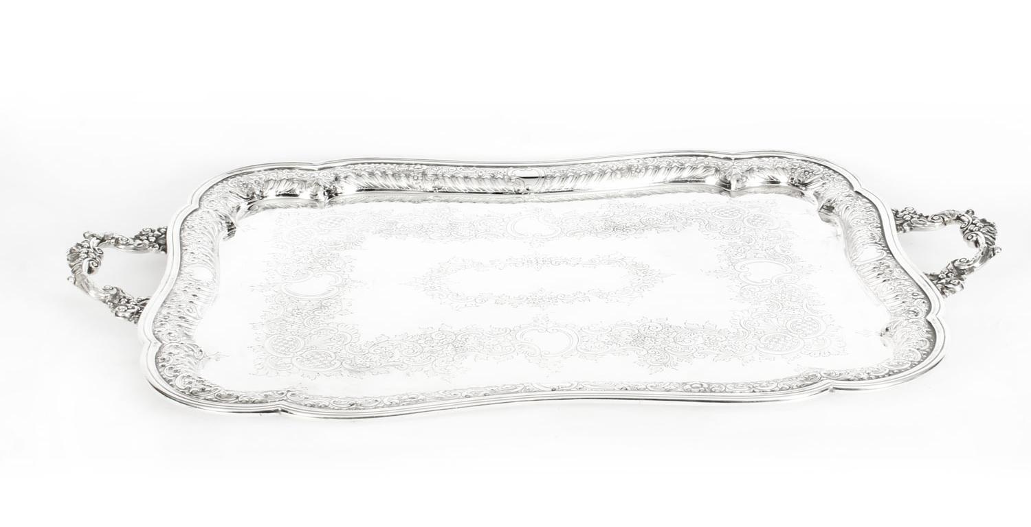 This is a wonderful antique English Victorian silver plated twin handled tray, bearing the makers mark TB&S for the renowned silversmiths Barker Bros as well as the Victorian lozenge registration mark which dates it at 1880.

This splendid large