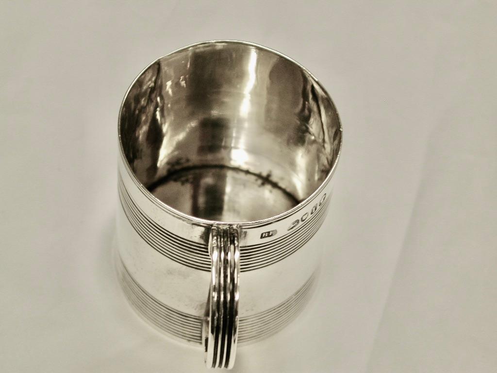 Antique Victorian Silver Ribbed Childs Tankard London 1864 Beare Falckle
Heavy quality childs mug made by hand with a ribbed handle.