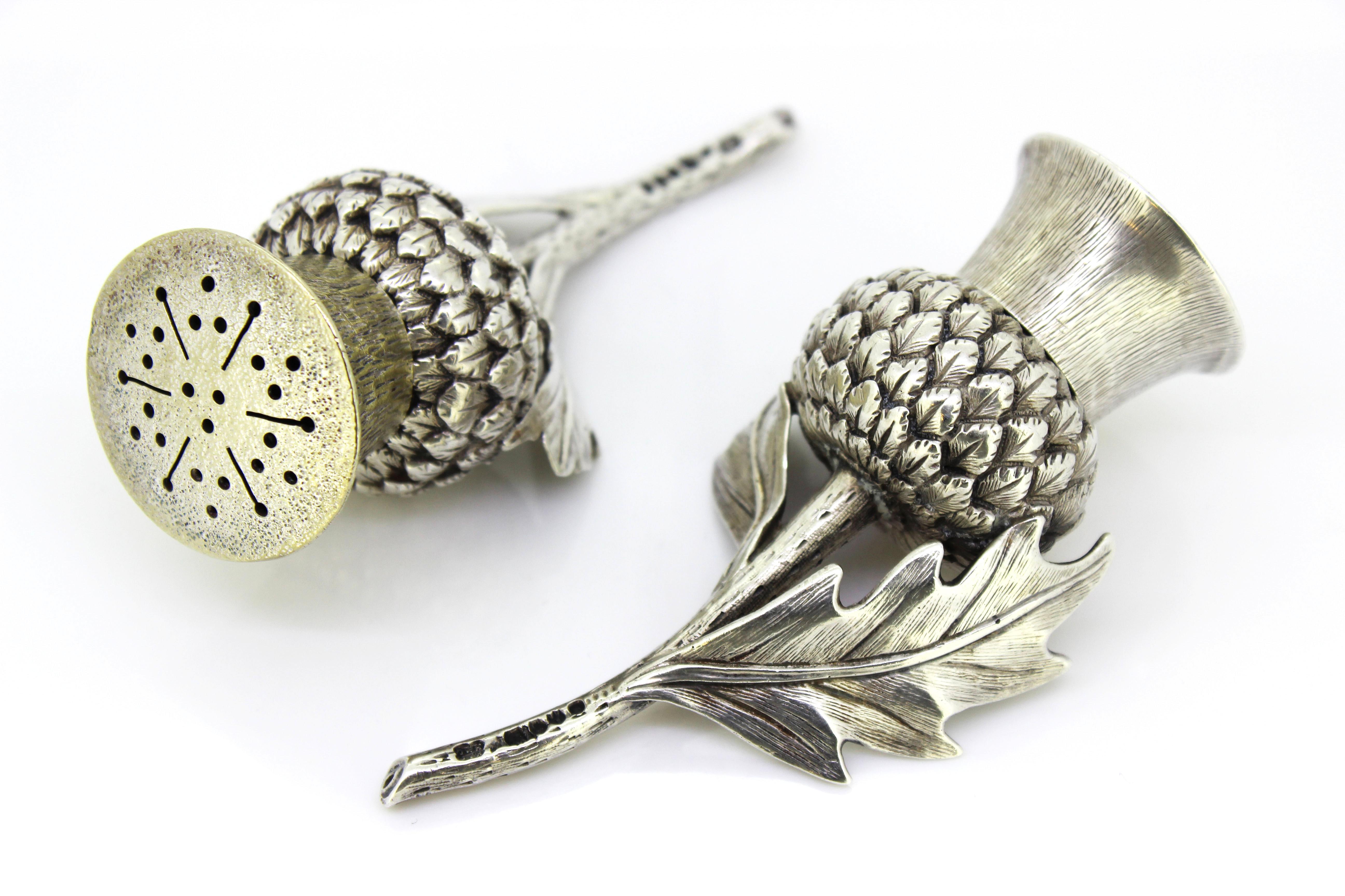 Antique Victorian silver salt and pepper shakers in a shape of thistle

Made in England, London, 1884
Maker: Jonathan Wilson Hukin and John Thomas Heath for Hukin & Heath

Dimensions:
Size : 10.2 x 5.3 x 2.8 cm
Weight: 154 grams

Condition: