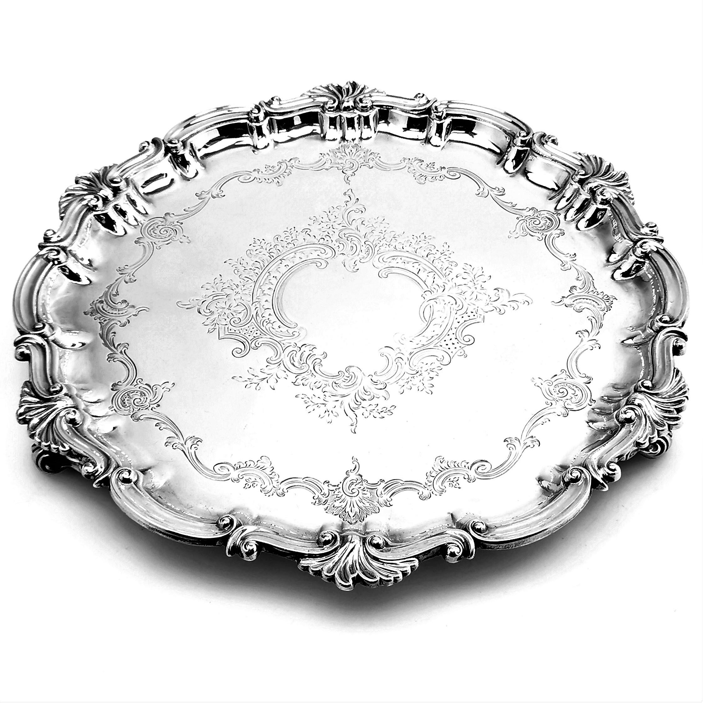 An antique Victorian solid silver Salver. This round Salver has an ornate border and features an engraved design on the inside. The salver stands on three scroll feet.

Made in London in 1896 by Thomas Bradbury & Sons.

Approx. Weight - 1074g /