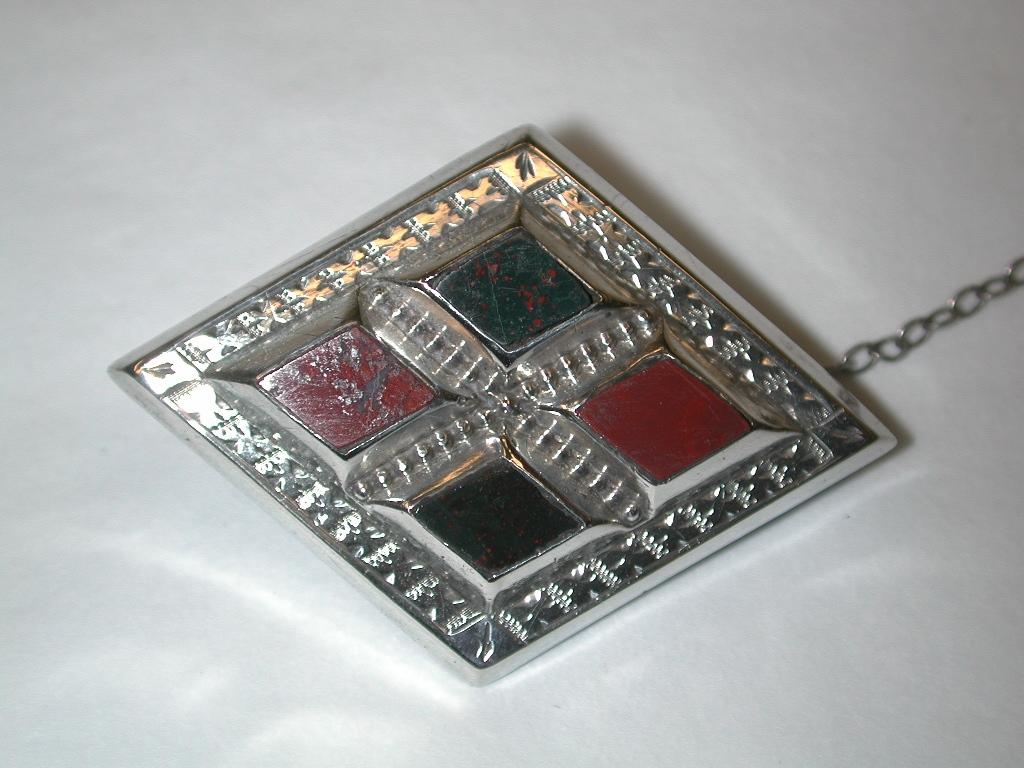 Antique Victorian Silver Scotch Pebble Brooch dated circa 1880
Unusual diamond shaped brooch with bright cut silver surround and set 
with 4 diamond shaped bloodstone and cornelian.