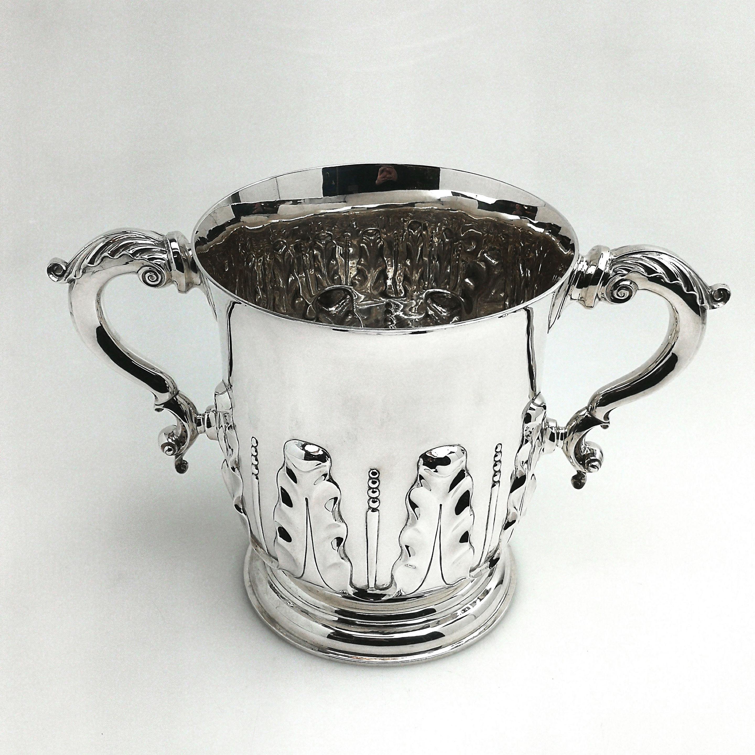 A substantial Antique Victorian two handled Cup, more than large enough to be used as an impressive Champagne cooler / wine ice bucket. The Cup has two large acanthus leaf topped scroll handles and is decorated with a stylised acanthus leaf pattern