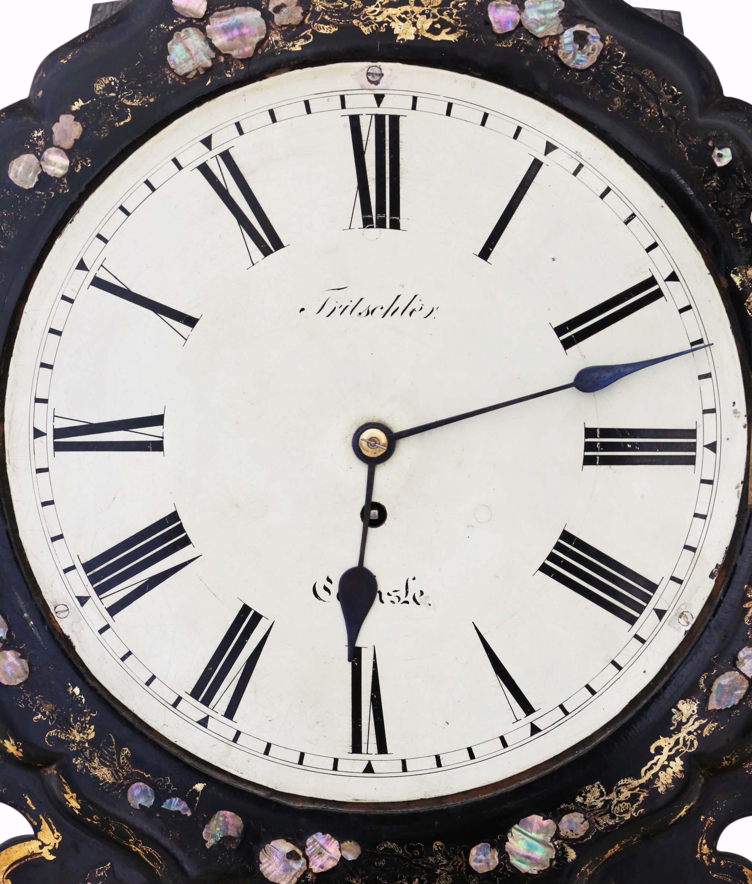 Antique and rare Victorian wall clock crafted from mother of pearl inlaid papier-mâché, featuring a single fusee mechanism. Exceptional in quality, it is challenging to find another of similar caliber.

This decorative piece showcases a black