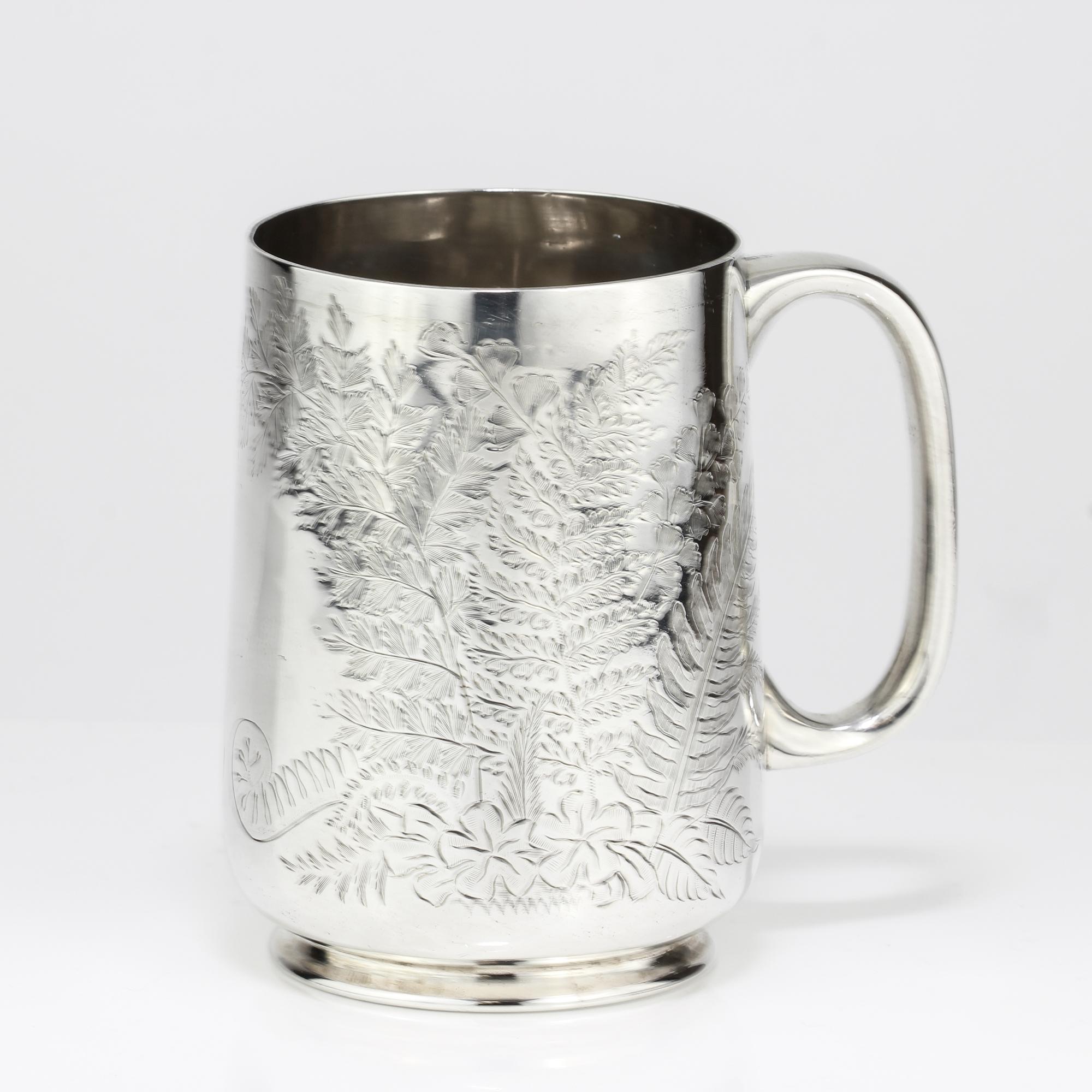 Antique Victorian small sterling silver mug with floral and leaf engravings
Maker: Thomas Bradbury & Sons
Made in: 1884
Fully hallmarked

Dimensions:
Size: 8.5 x 6.5 x 9 cm
Weight: 123 grams

Condition: Minor wear and tear from general