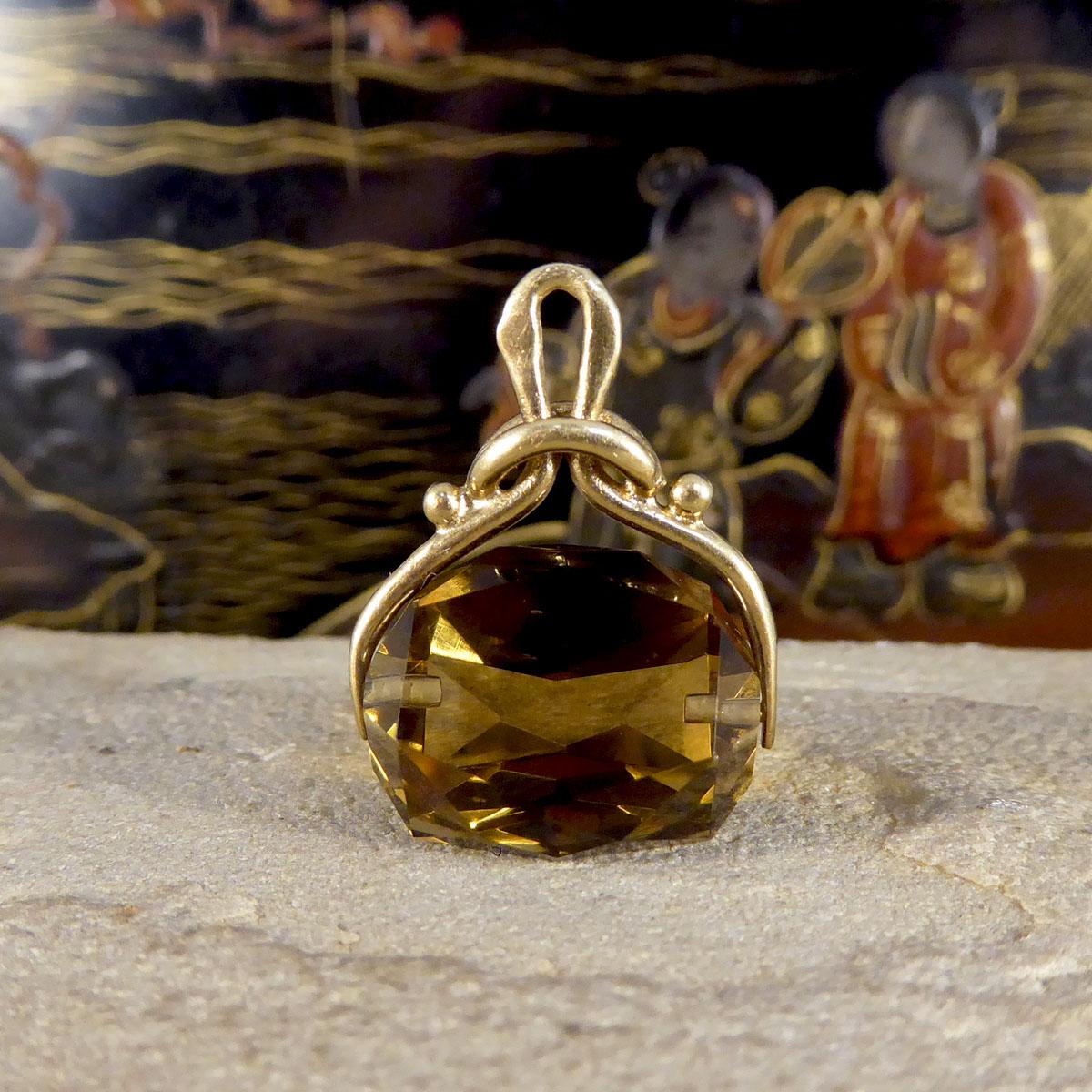 An original Victorian Smokey Quartz fob pendant. This great quality and crisp triple sided, faceted Smokey Quartz gemstone is mounted in decorative 9ct Yellow Gold. The Gold setting has beautiful detail leading to an almost tied knot design, stamped