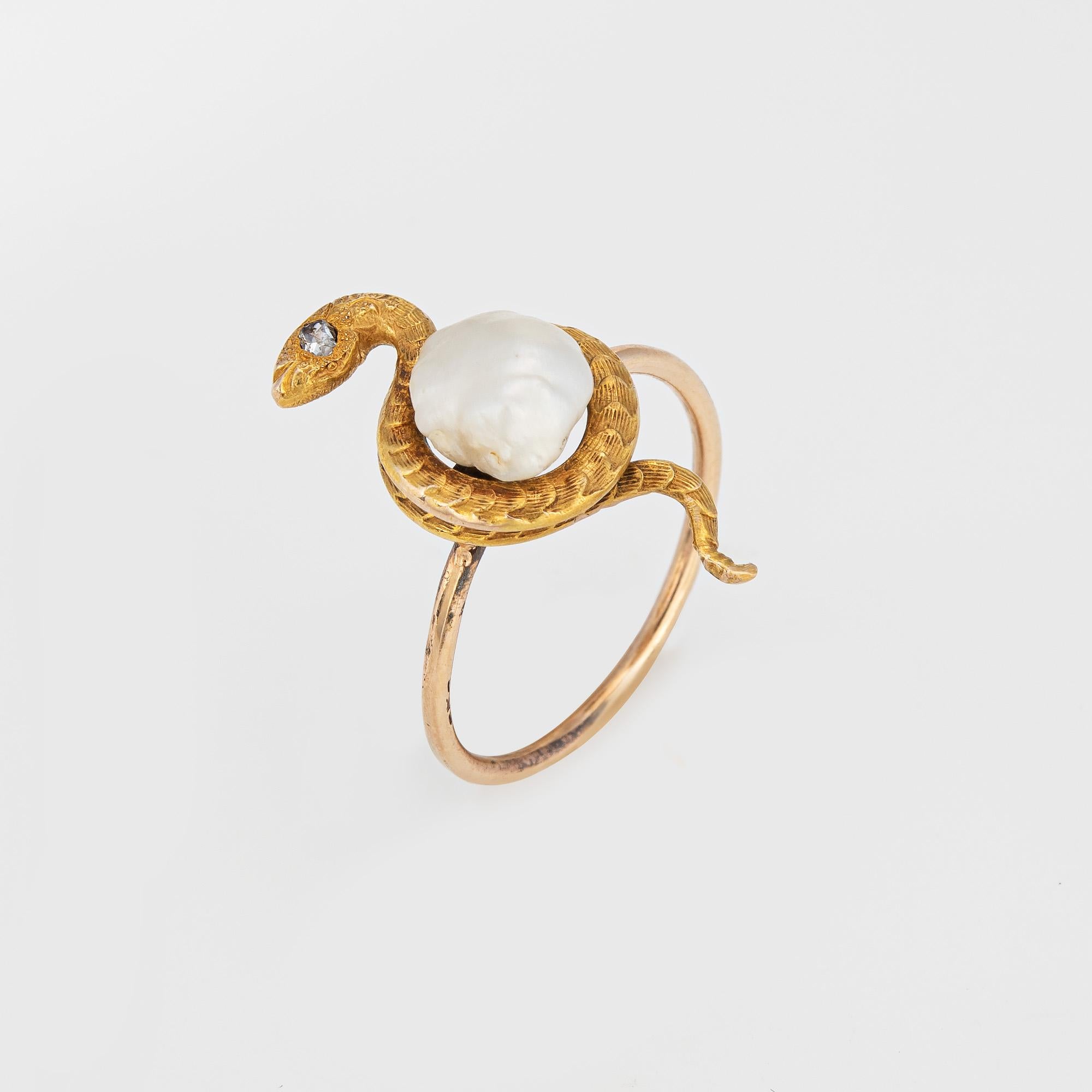 Originally an antique Victorian era stick pin (circa 1880s to 1900s), the diamond & pearl snake ring is crafted in 14 karat yellow gold.

The ring is mounted with the original stick pin. Our jeweler rounded the stick pin into a slim band for the