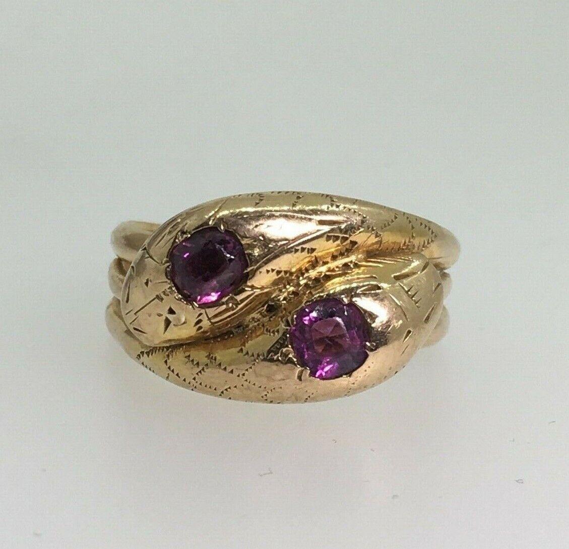 An Antique (Victorian) Double Snake Shaped Spinel Ring

featuring 2 natural oval shaped Spinels 
of fine deep vibrant purple colour
of 0.80ct in total (0.40ct each)

bearing English hallmarks: Chester, c1885 and maker’s mark 
Meticulously crafted 9K