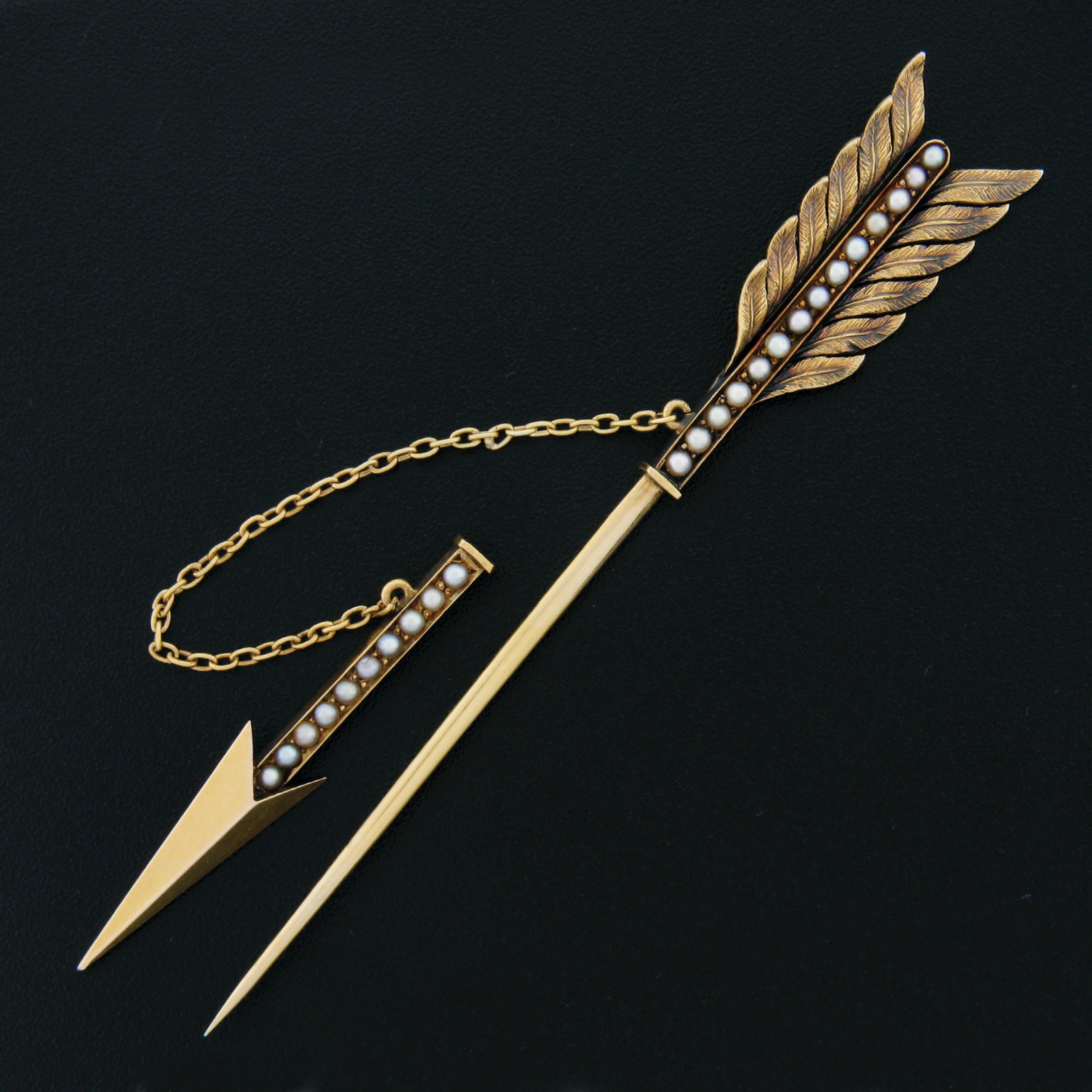 This incredible antique pin brooch was crafted from solid 14k yellow gold during the Victorian era and features a large, outstandingly made, and detailed arrow design that is neatly set with cultured seed pearls throughout. The adorable pearls