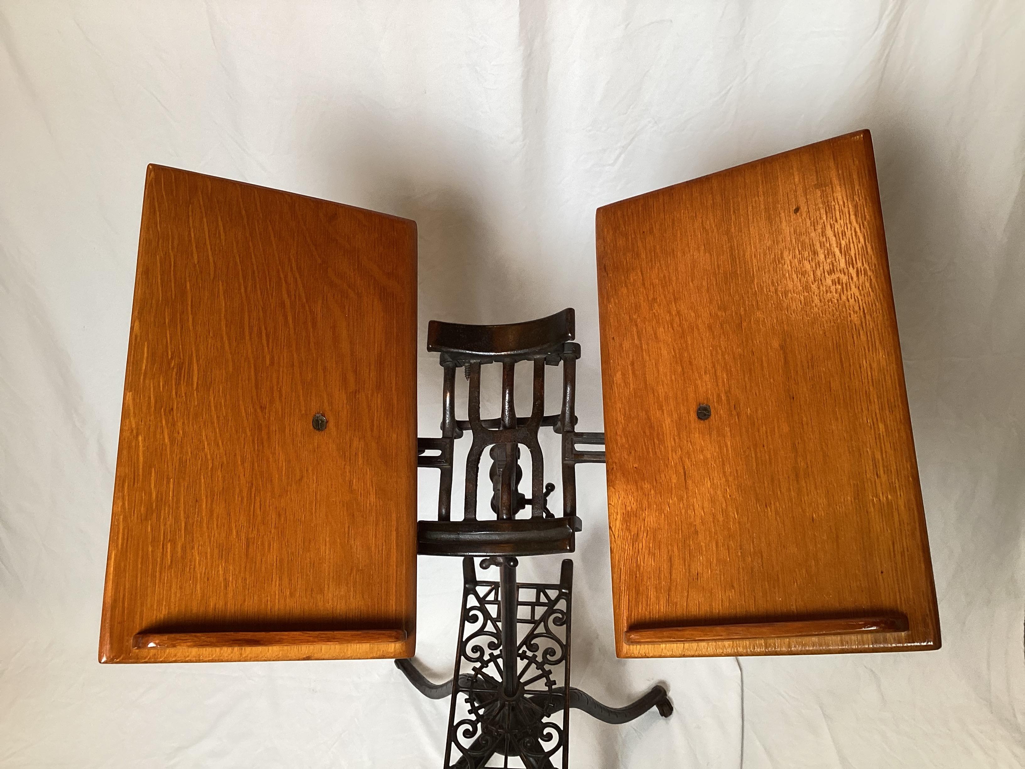 Détail en fer joliment moulé, les pieds se replient.  Les pieds sont ornés d'une finition cuivrée.  Chêne nouvellement fini.  Hauteur et taille du livre réglables.  Pièce rare et inhabituelle.